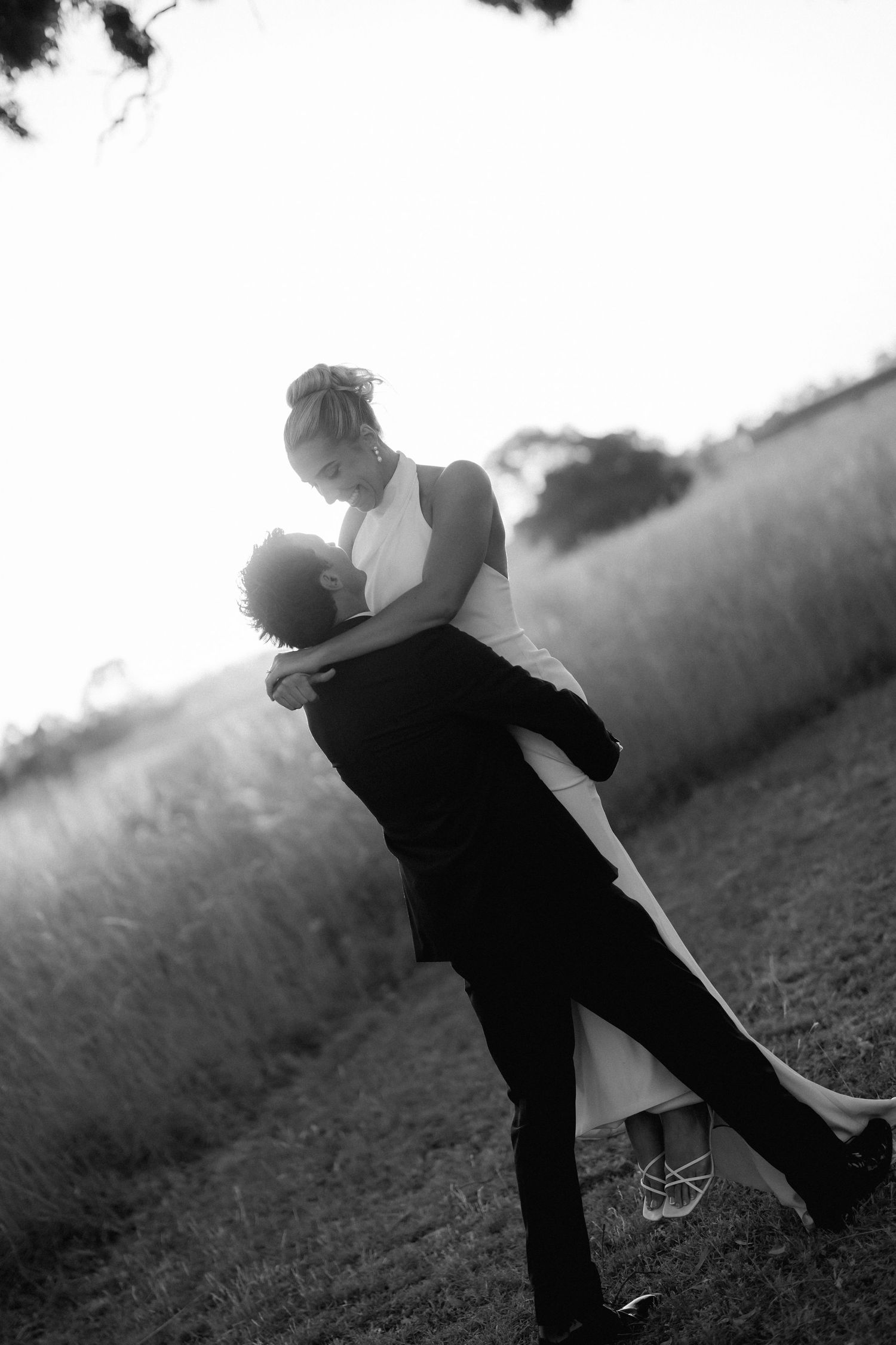 Black and white romantic wedding couple portrait in dramatic lighting.