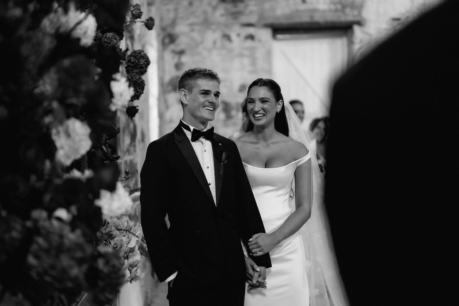 Black and white wedding photos showing intimate moments between a couple during their celebration.