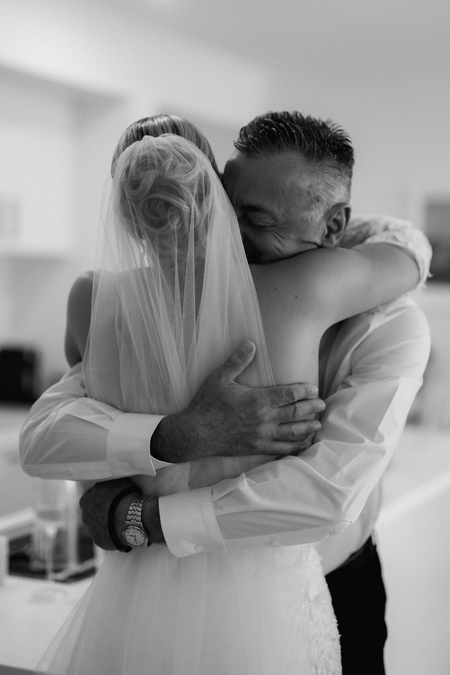 Romantic black and white wedding photography sequence showing an intimate embrace.