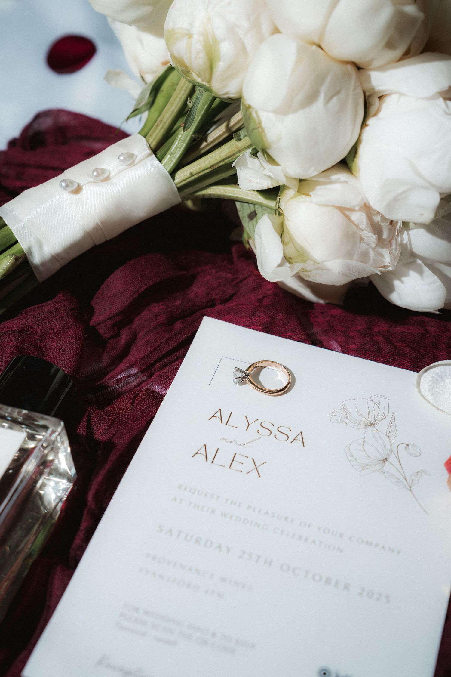 Wedding invitation with white roses and burgundy velvet fabric details.