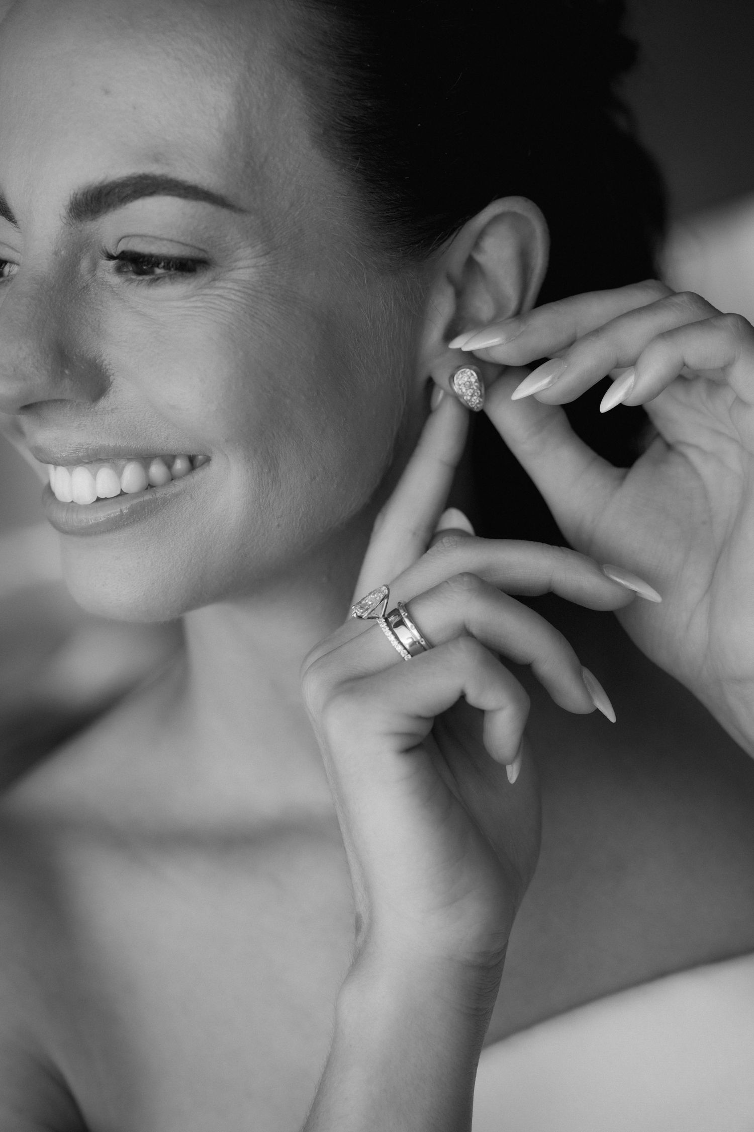 Black and white close-up portrait series showing a bride's radiant smile and jewelry details.
