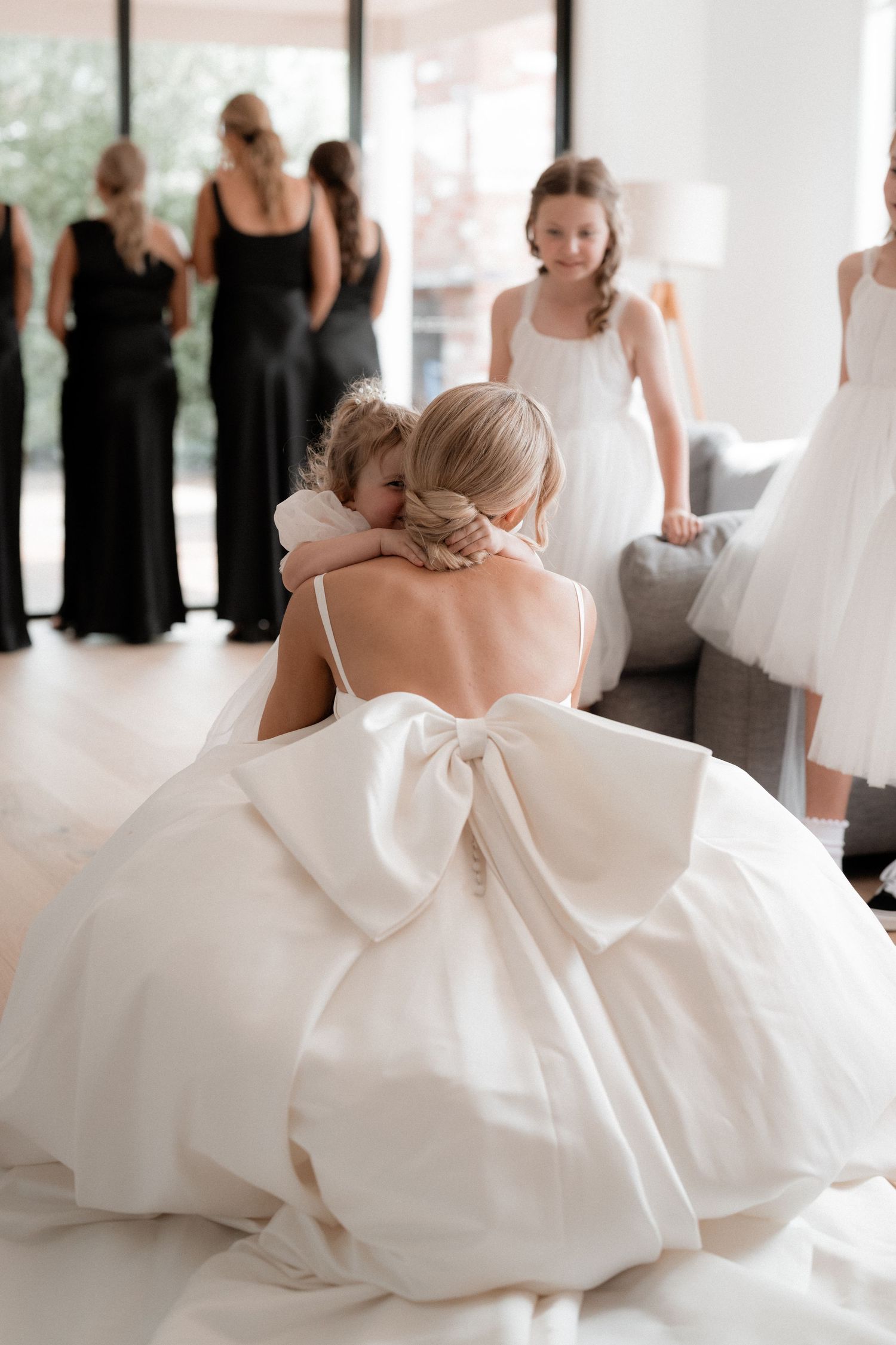 A bride in a flowing white gown twirls gracefully with her dress billowing out during a wedding reception.