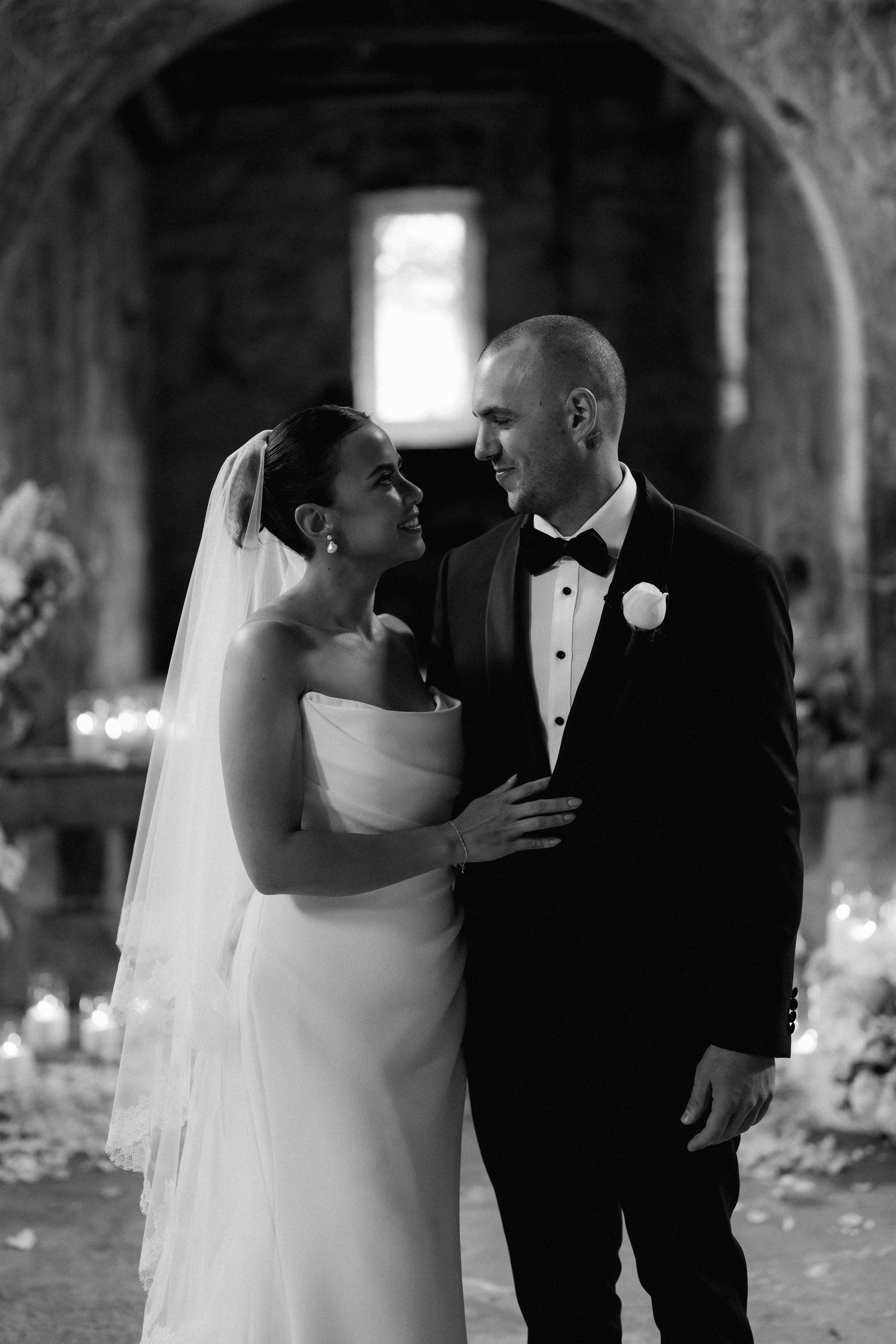 Romantic black and white sequence of couple sharing intimate moments in rustic venue.