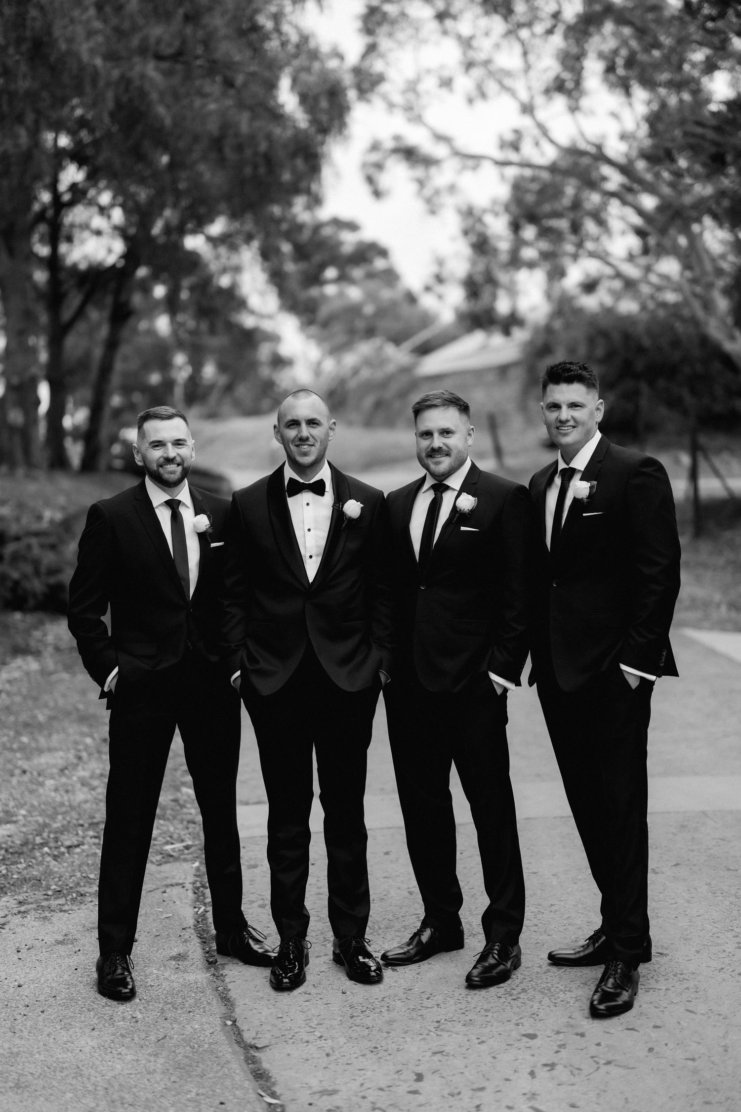 Black and white sequence of groomsmen in classic tuxedos posing outdoors.