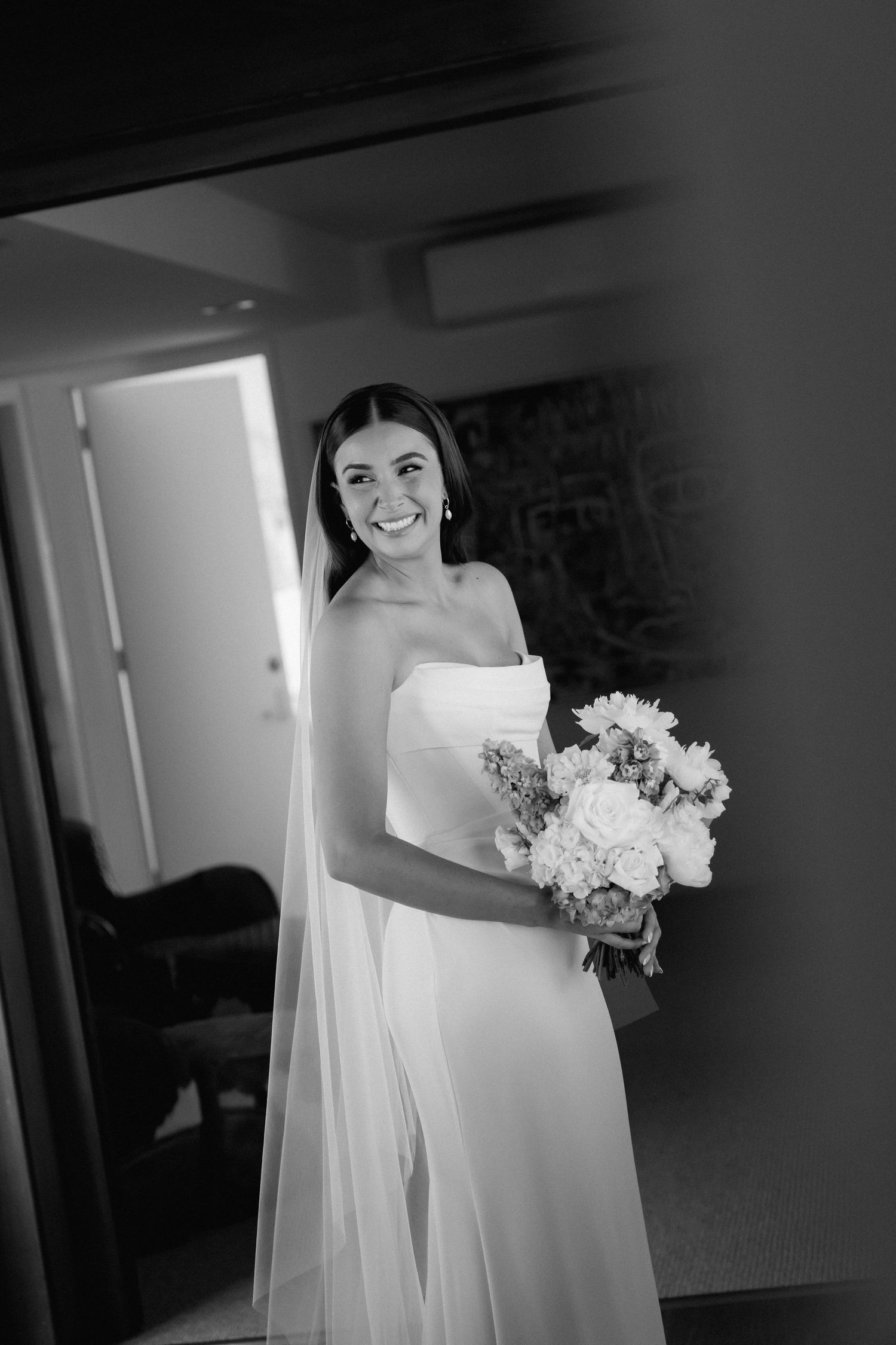 Black and white photos of a bride holding a white floral bouquet.