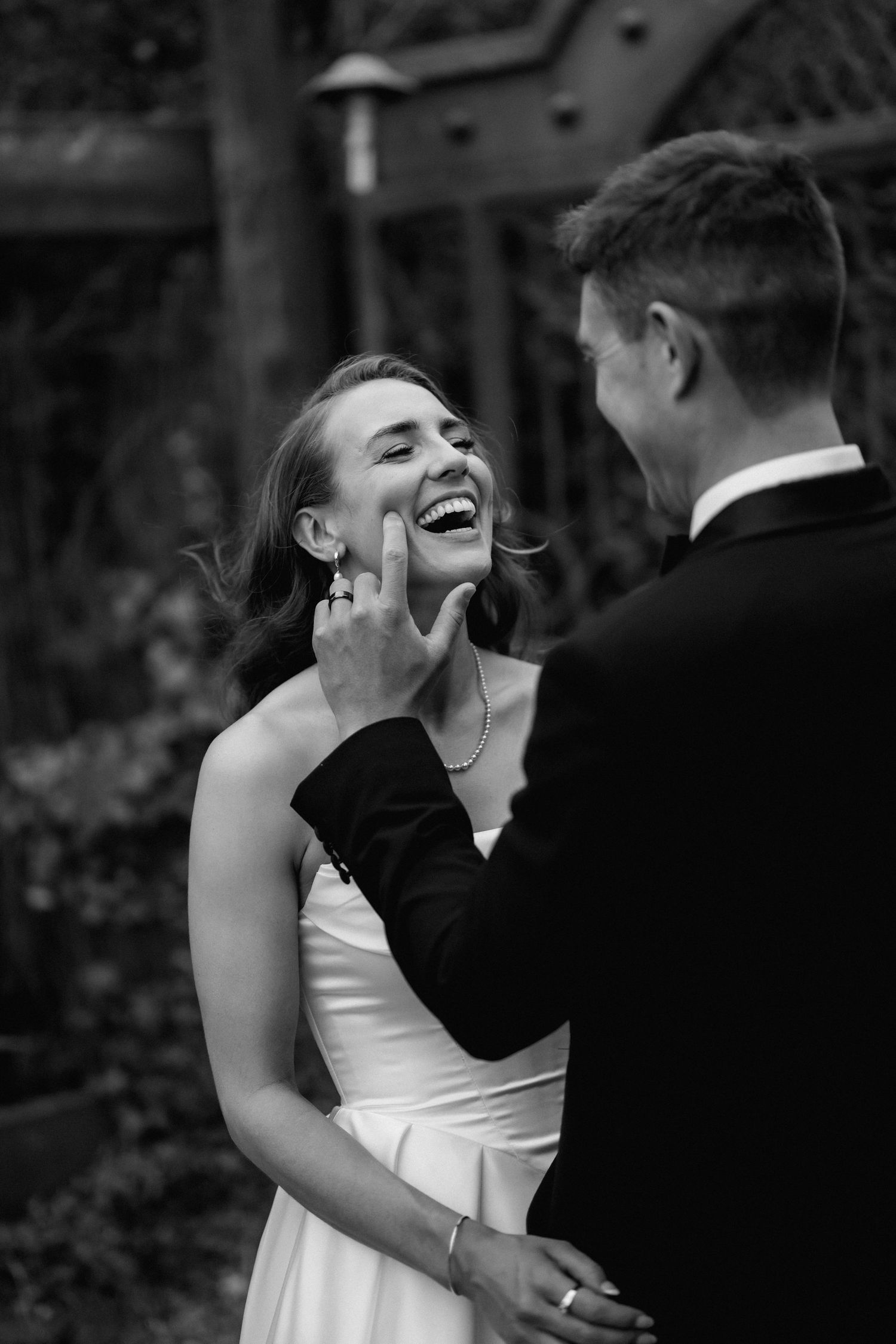 A joyful black and white wedding photo series showing intimate embraces and laughter between a couple.