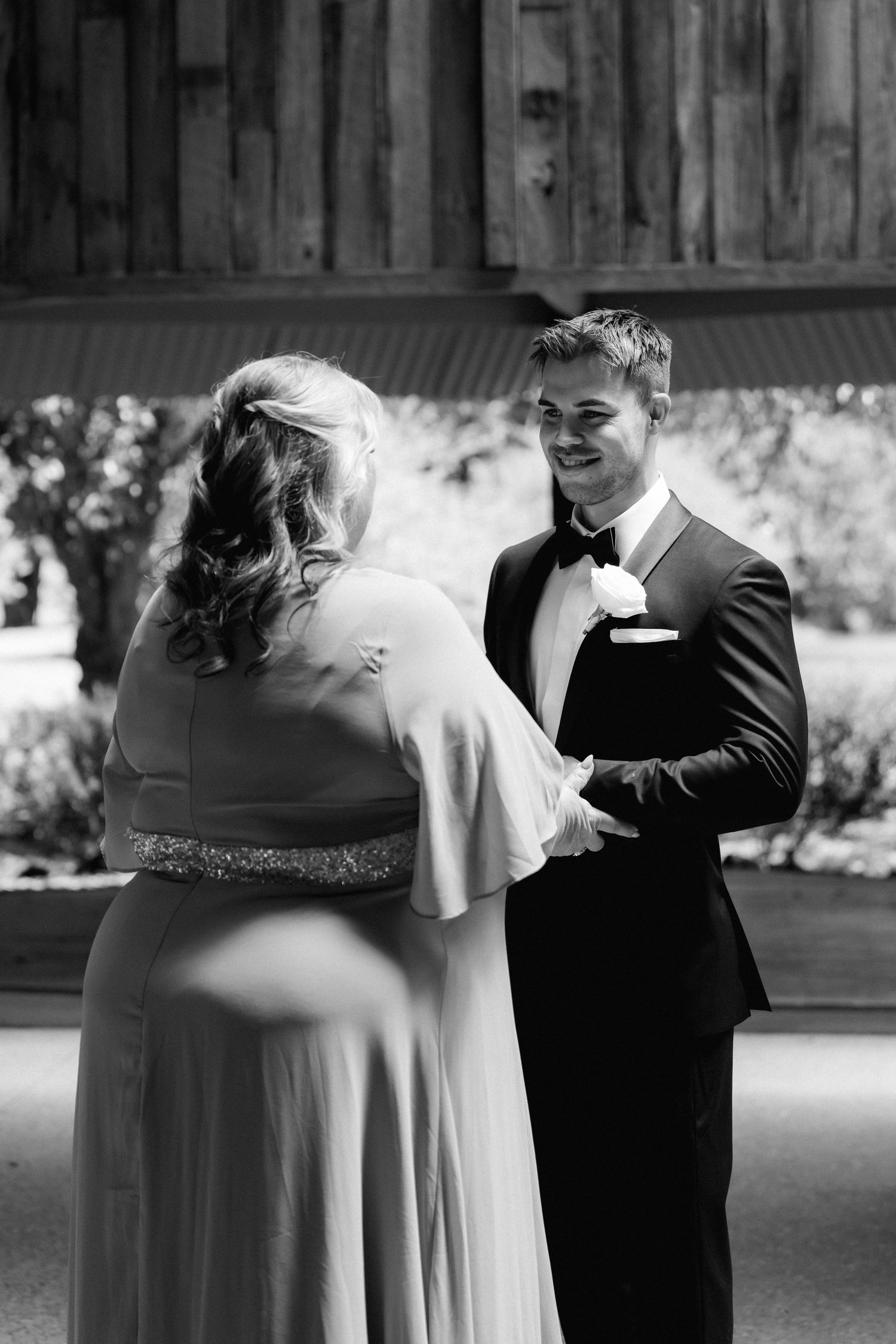 A couple shares a romantic dance moment at their wedding reception in black and white.