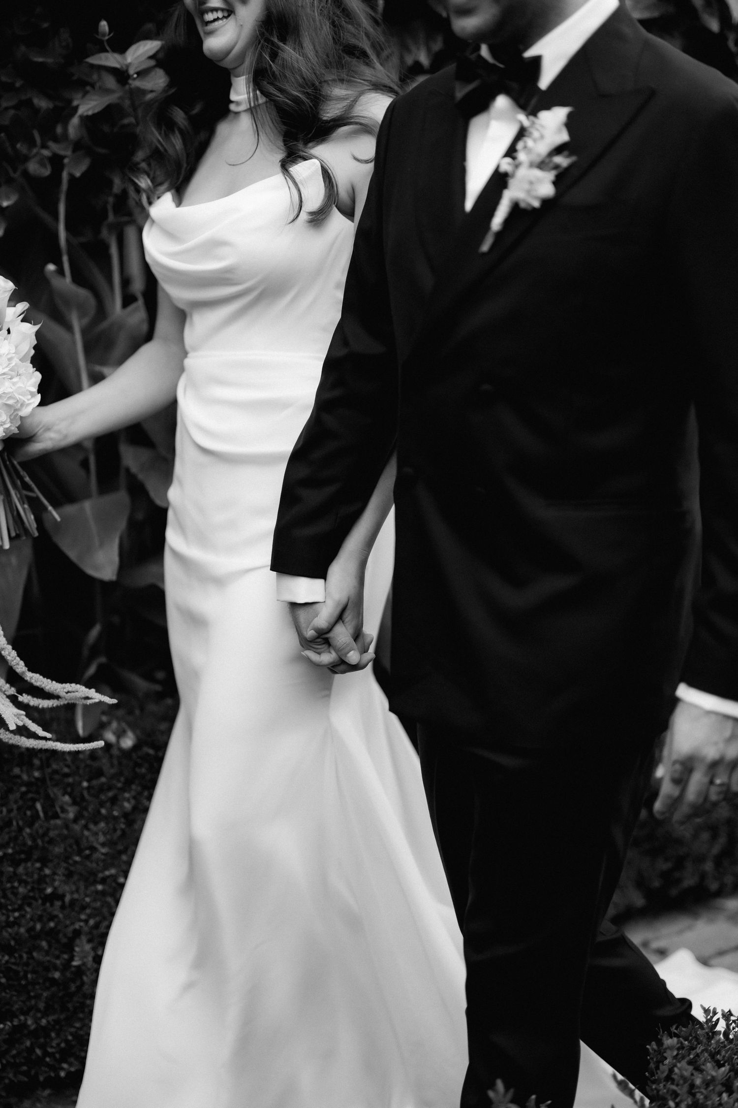 A couple dances and celebrates at their wedding reception, with the bride in white and groom in black.