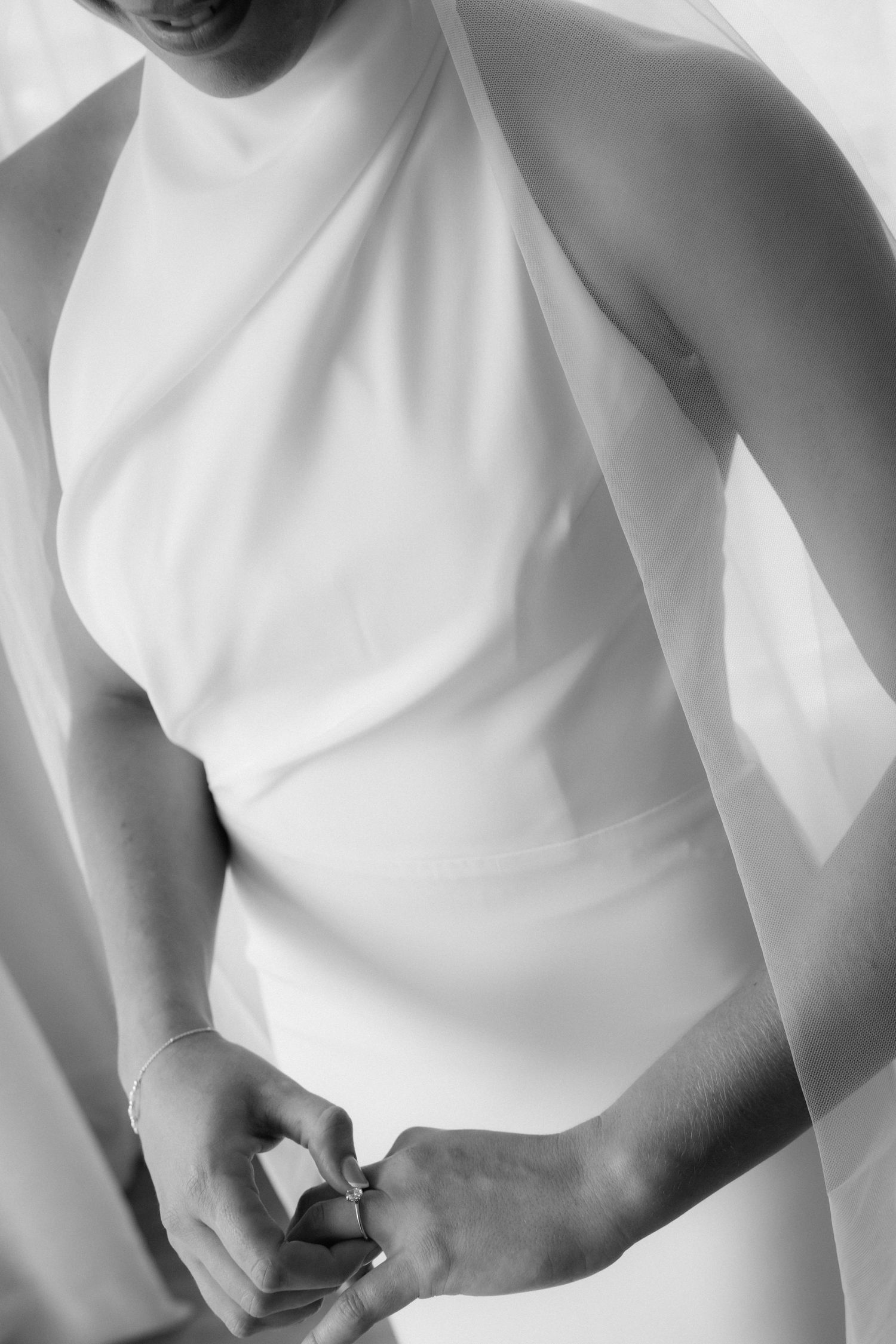 Close-up abstract details of white wedding dress fabric and silhouettes.