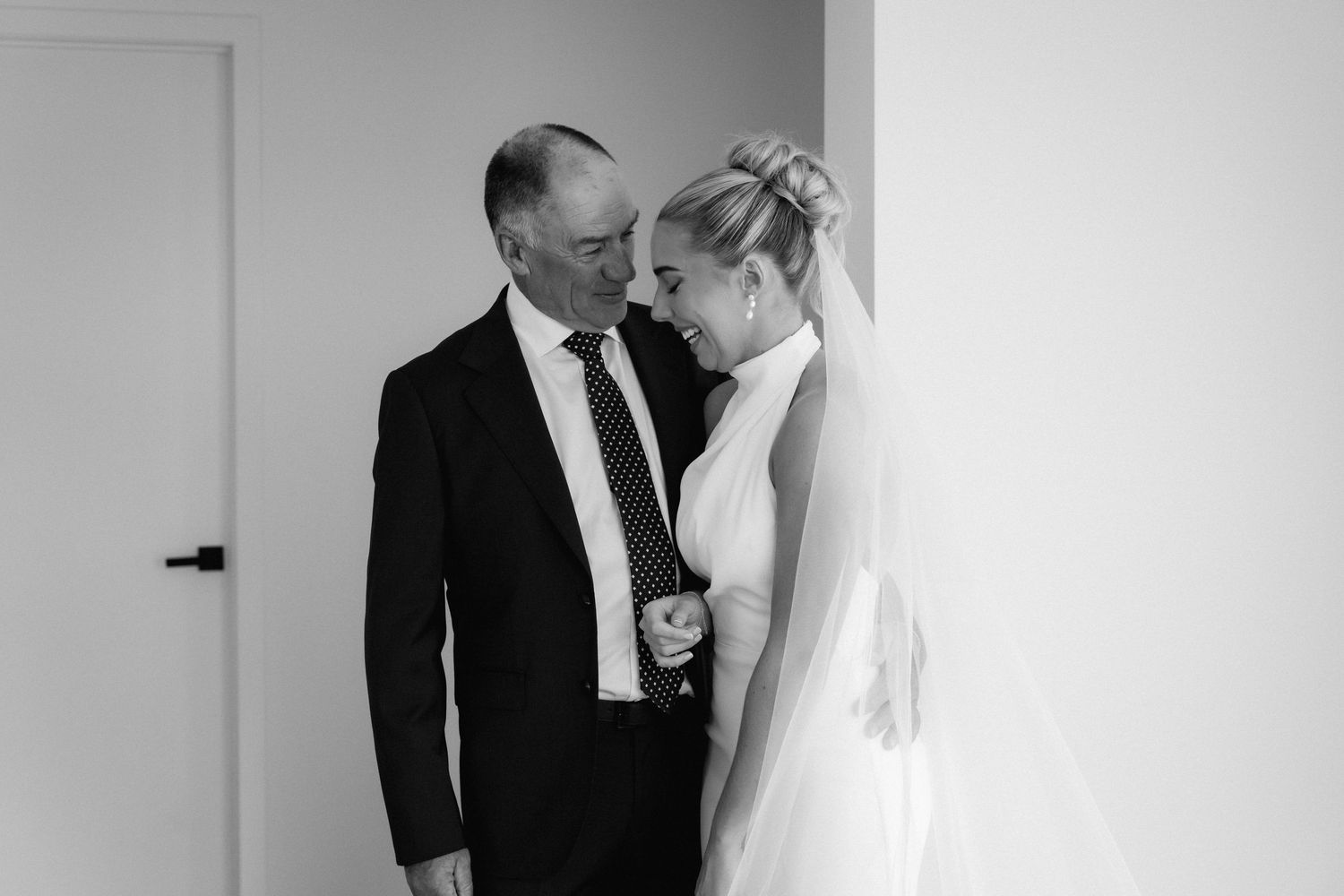 Black and white wedding portraits showing intimate moments between couples in formal attire.