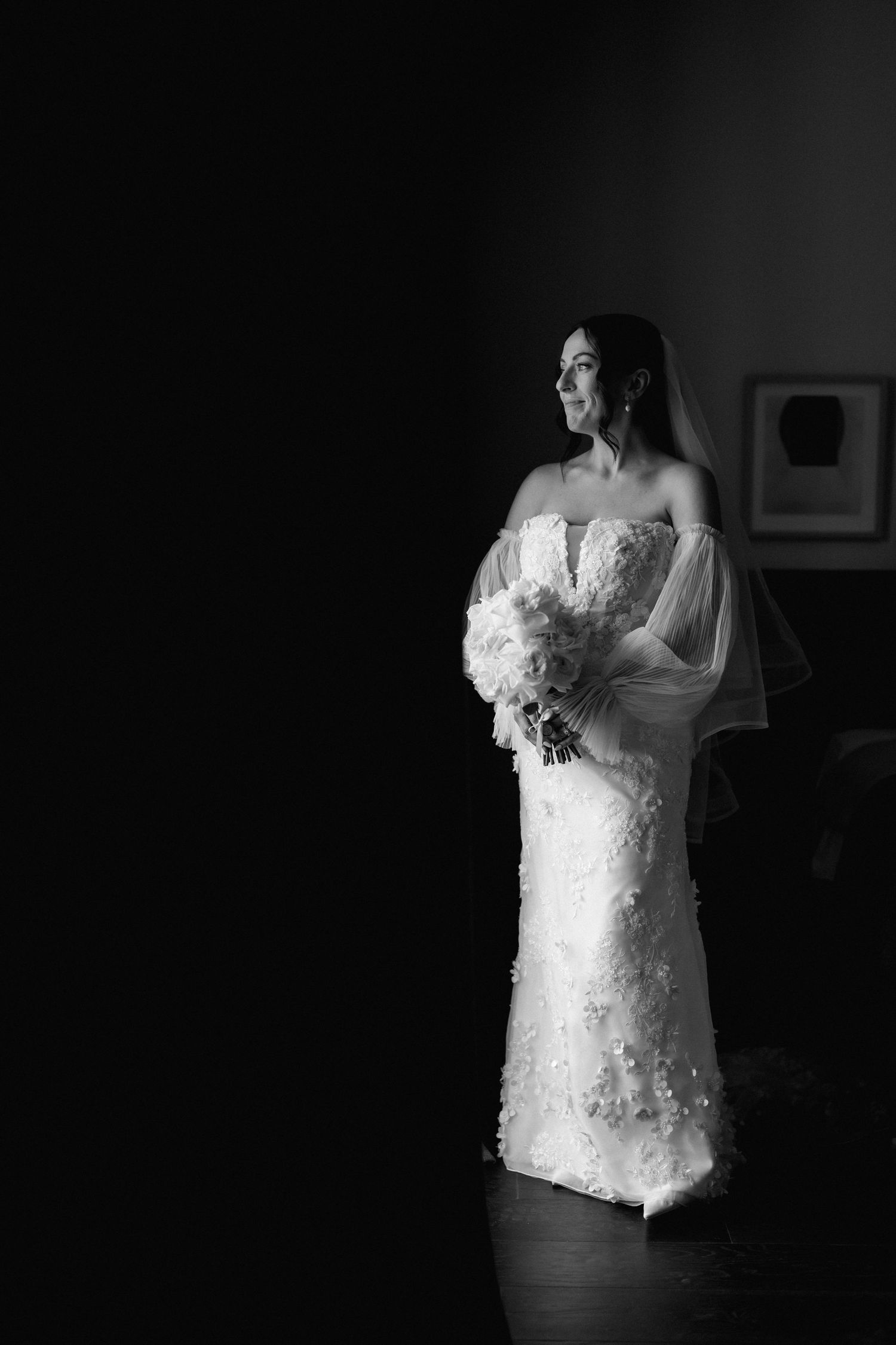 Black and white portraits of a bride in a lace wedding dress against a dark background.