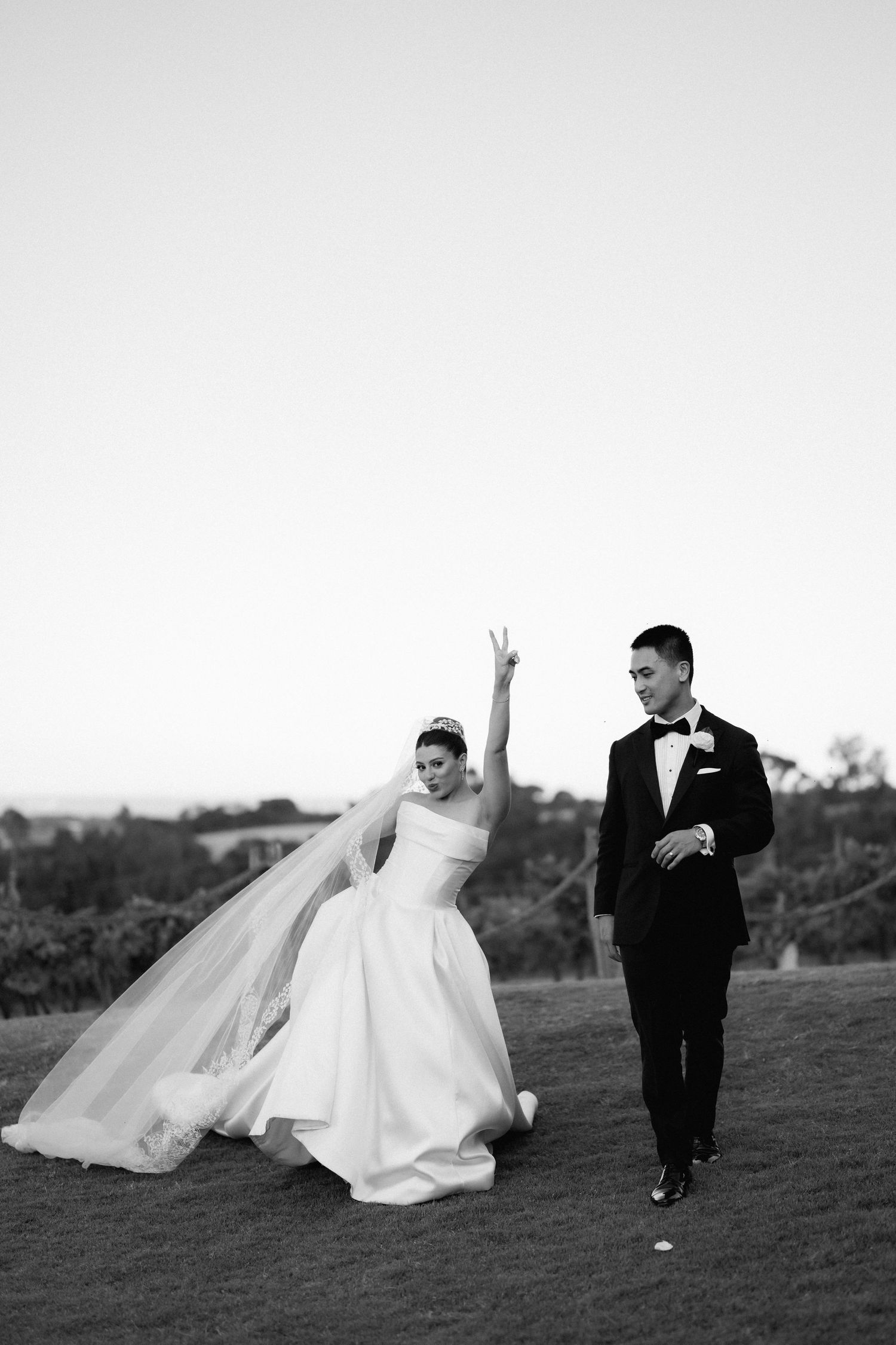 Playful black and white photos of couple running and dancing in formal attire.