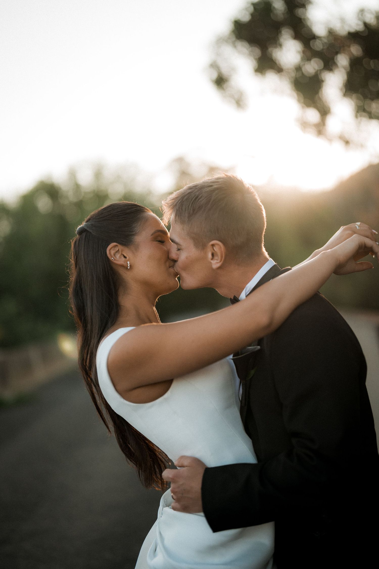 Sunset silhouette of couple sharing romantic moment in natural outdoor setting.