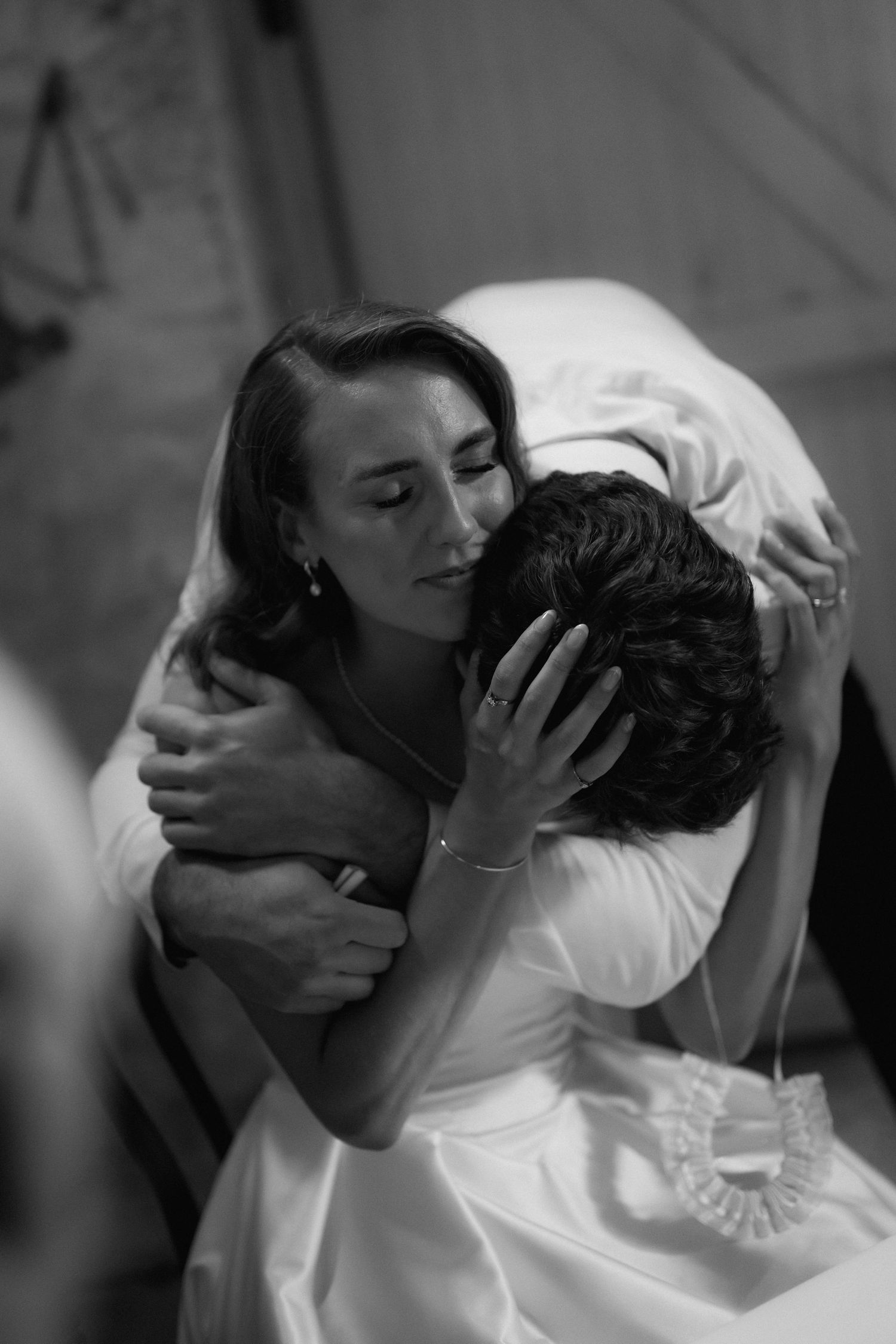 Intimate black and white portrait of newlyweds sharing a romantic moment.