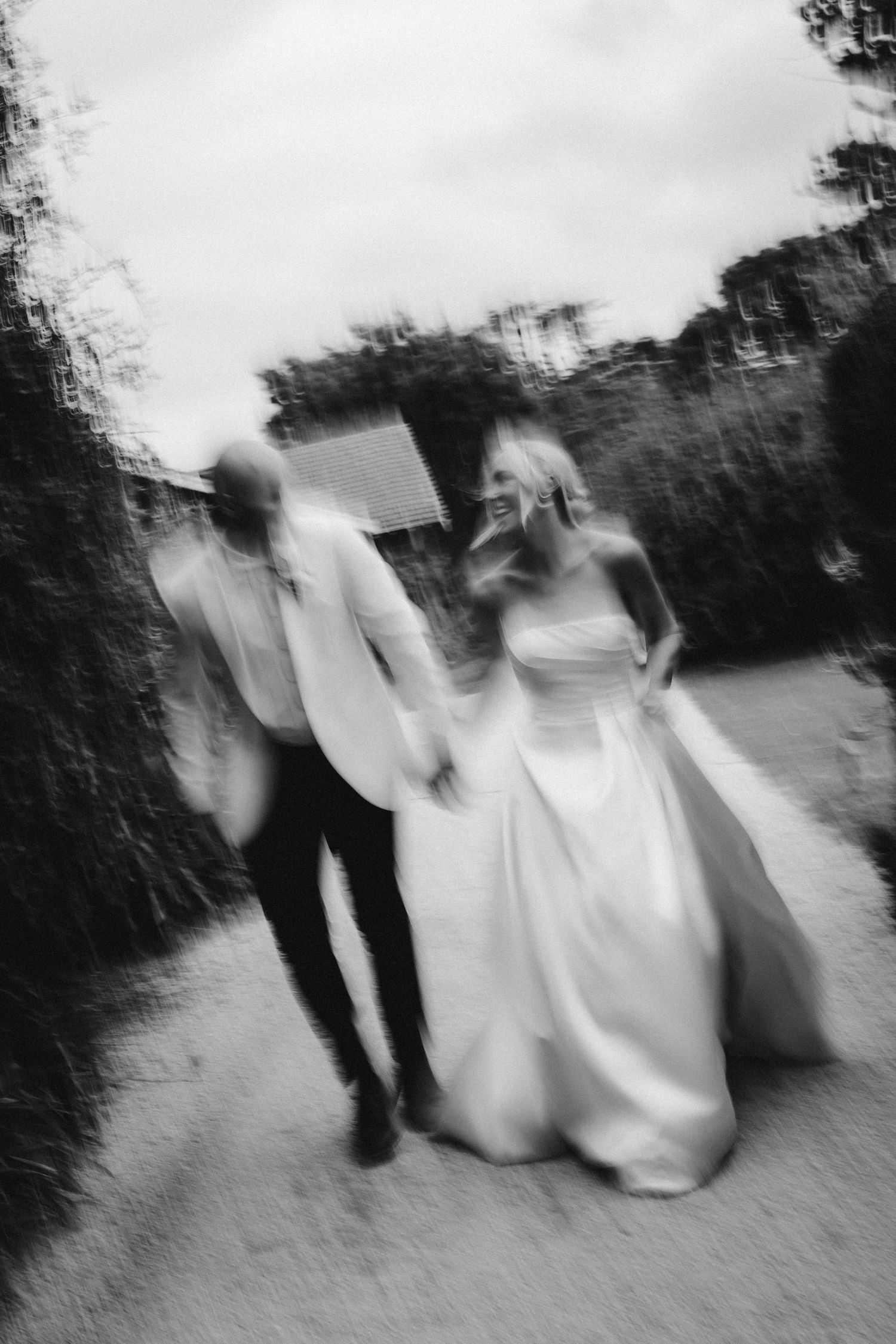 Artistic black and white motion blur photograph of a couple walking together.