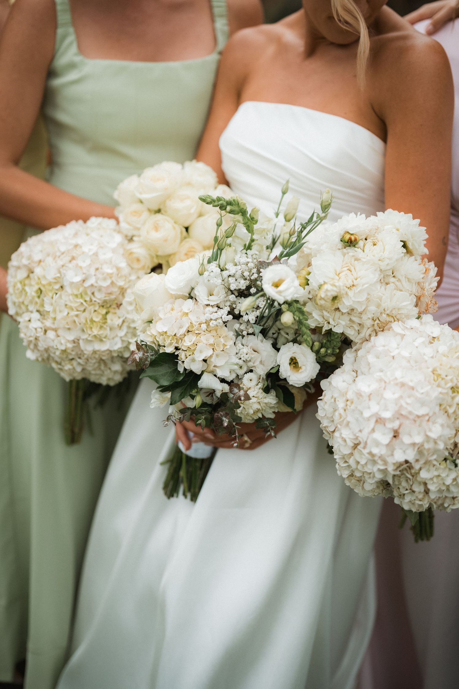 Beautiful white hydrangea and rose bouquets with sage green bridesmaid dress.