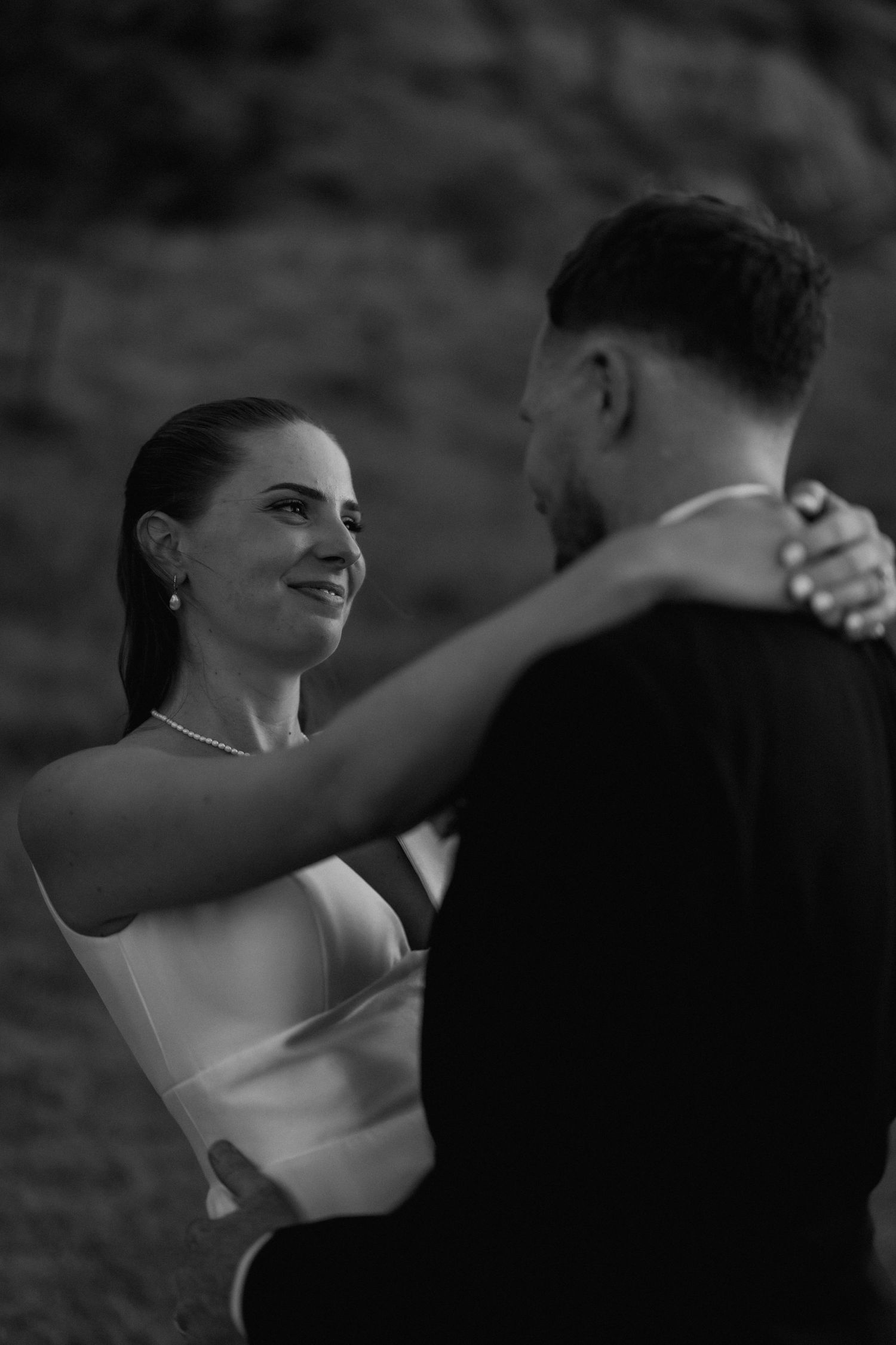 Intimate black and white photo of a couple dancing at their wedding reception.
