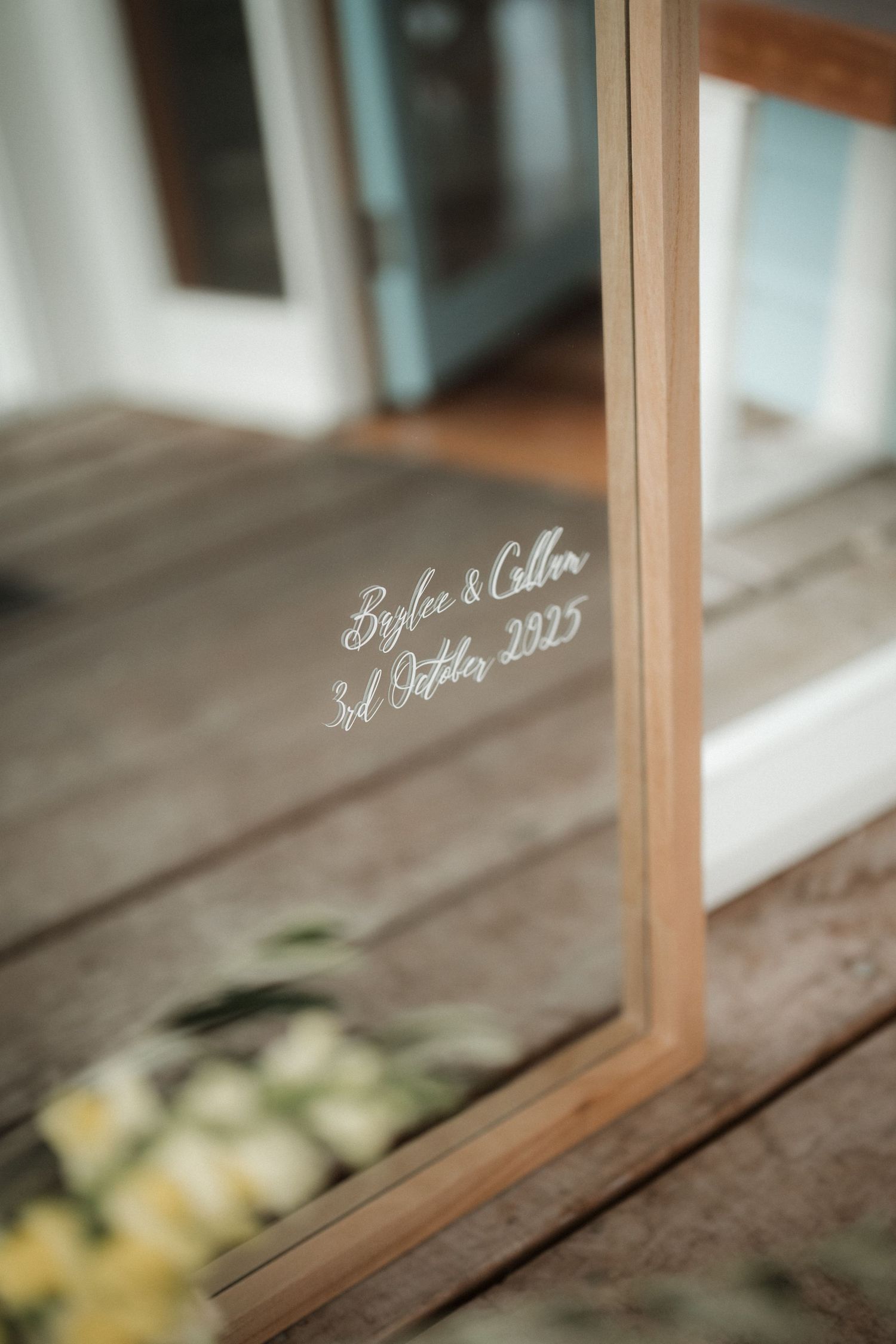 Close-up of elegant wedding date inscription on glass in wooden frame.