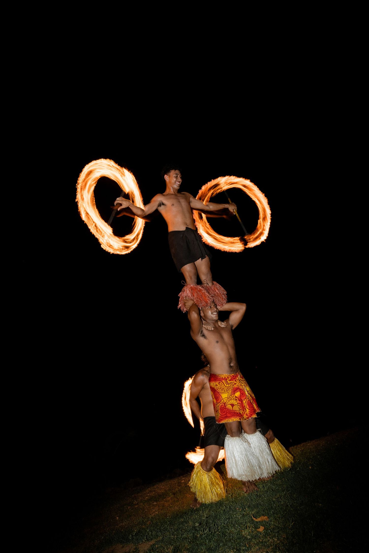 Fire knife performers create spectacular light trails in the dark as they showcase traditional Polynesian dance moves.