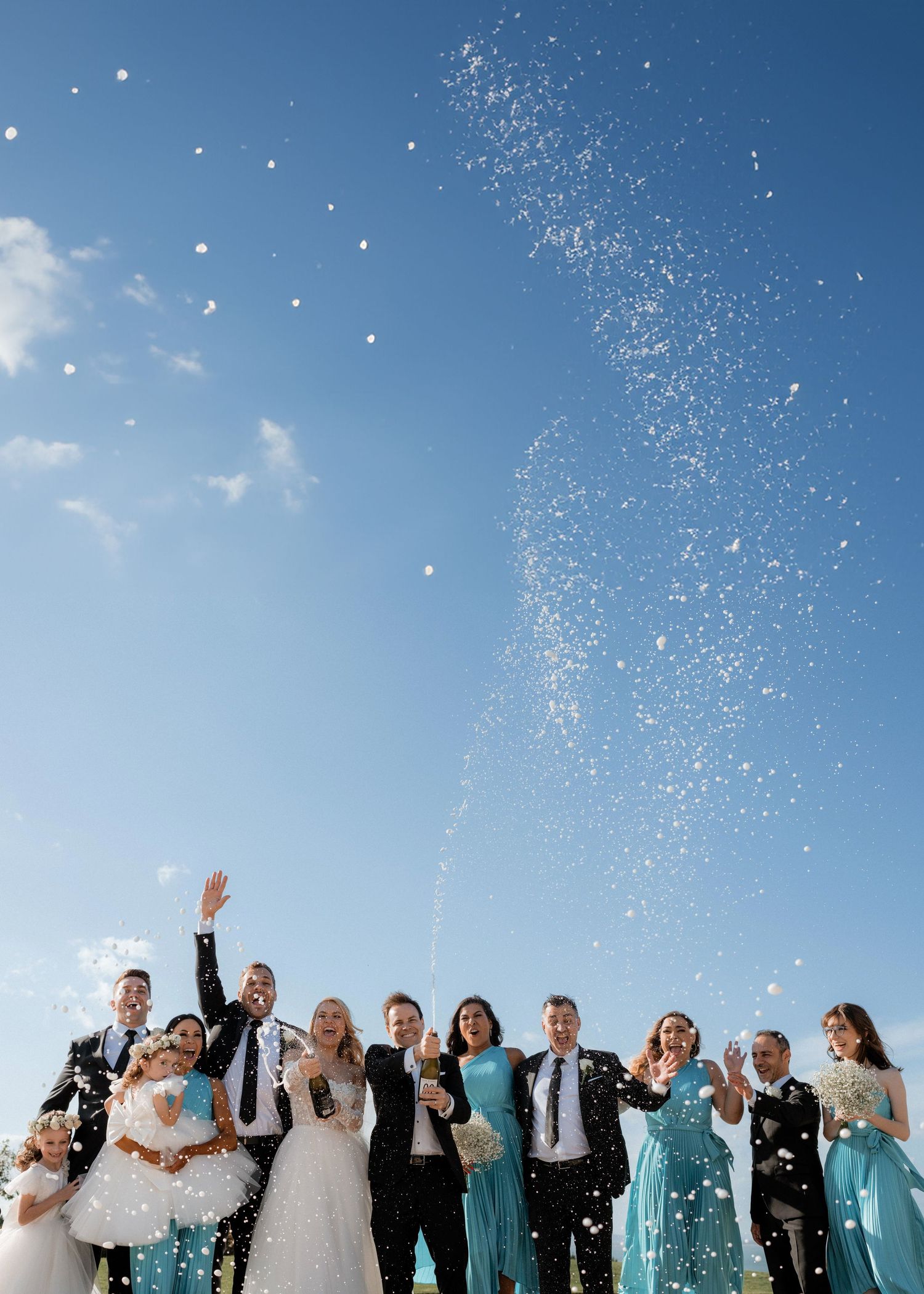 A celebratory moment with confetti flying against a bright blue sky.