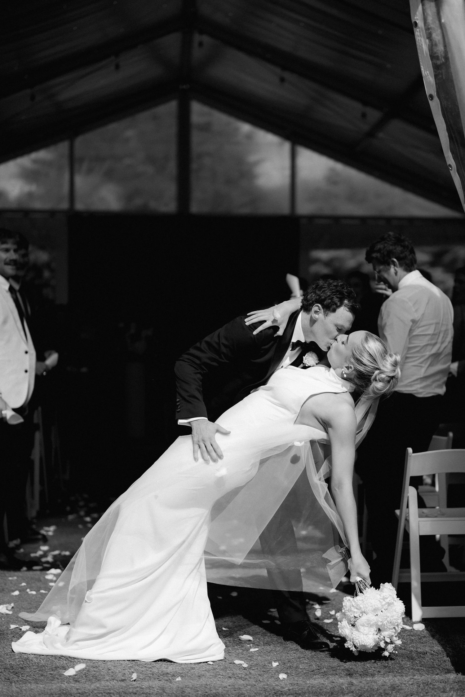 A romantic wedding dance sequence showing a couple performing a dramatic dip move under a tent.