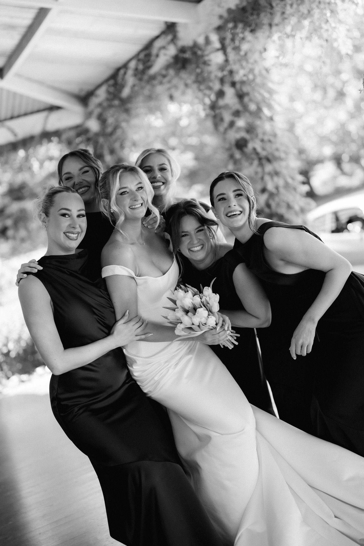 Bridal party shares candid laughing moments in black and white photo sequence.