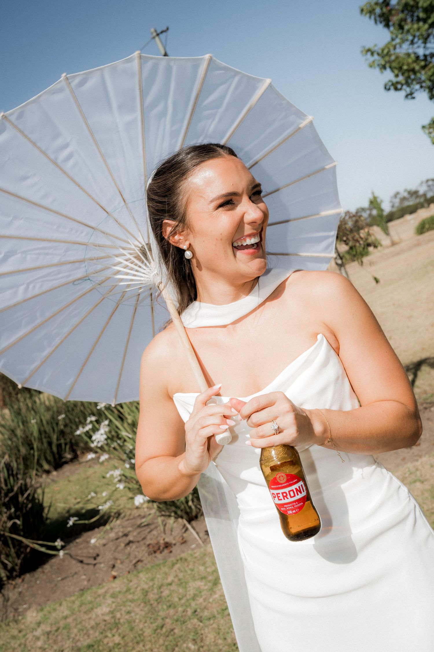 A series of photos showing someone in white holding a parasol and drink bottle in an outdoor setting.