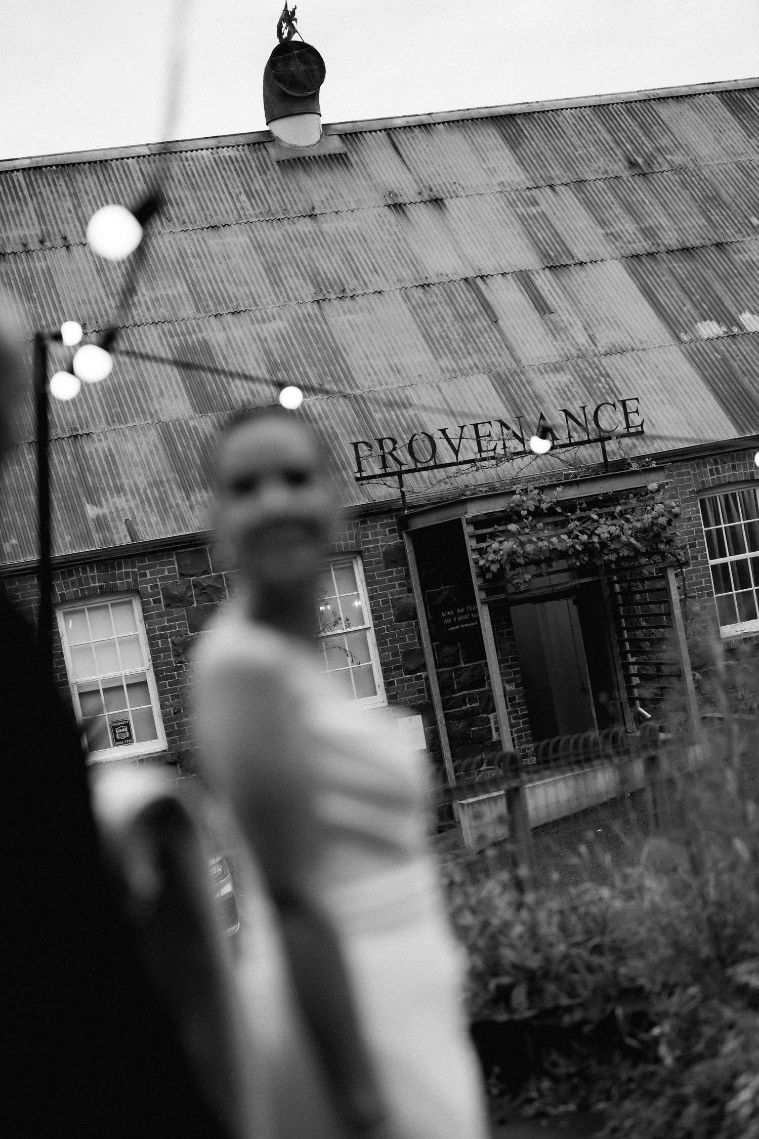 Artistic black and white wedding photos outside historic Provenance building.