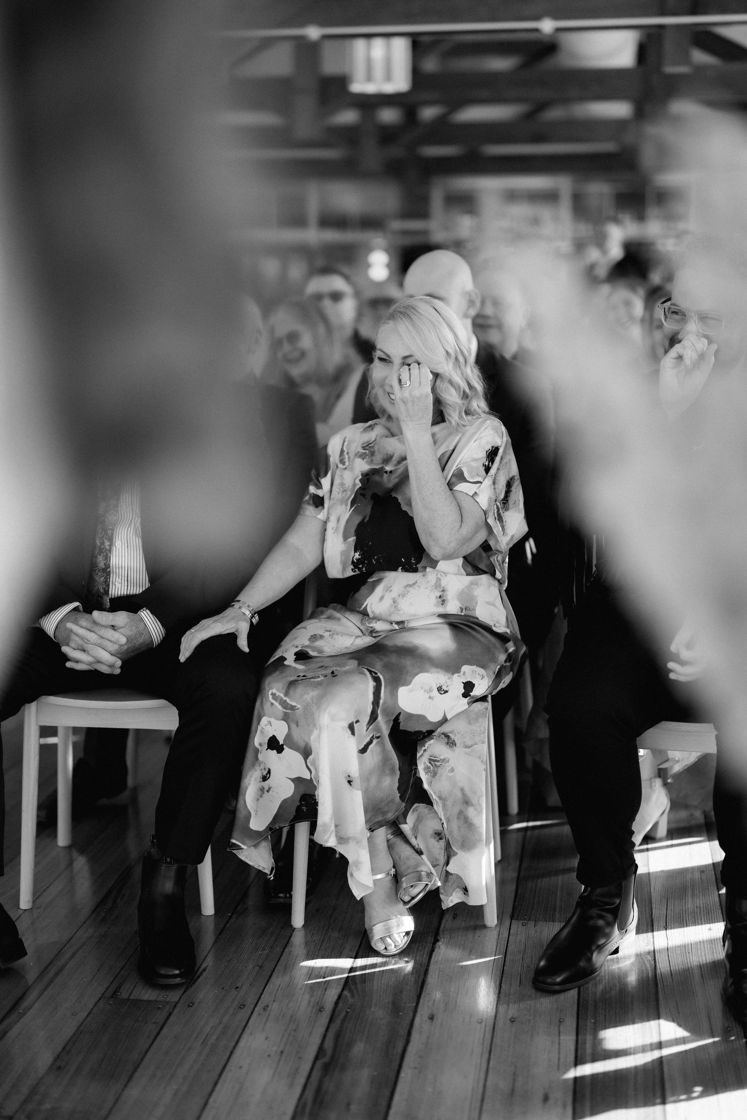 A series of black and white images showing seated figures in formal attire with dramatic lighting.