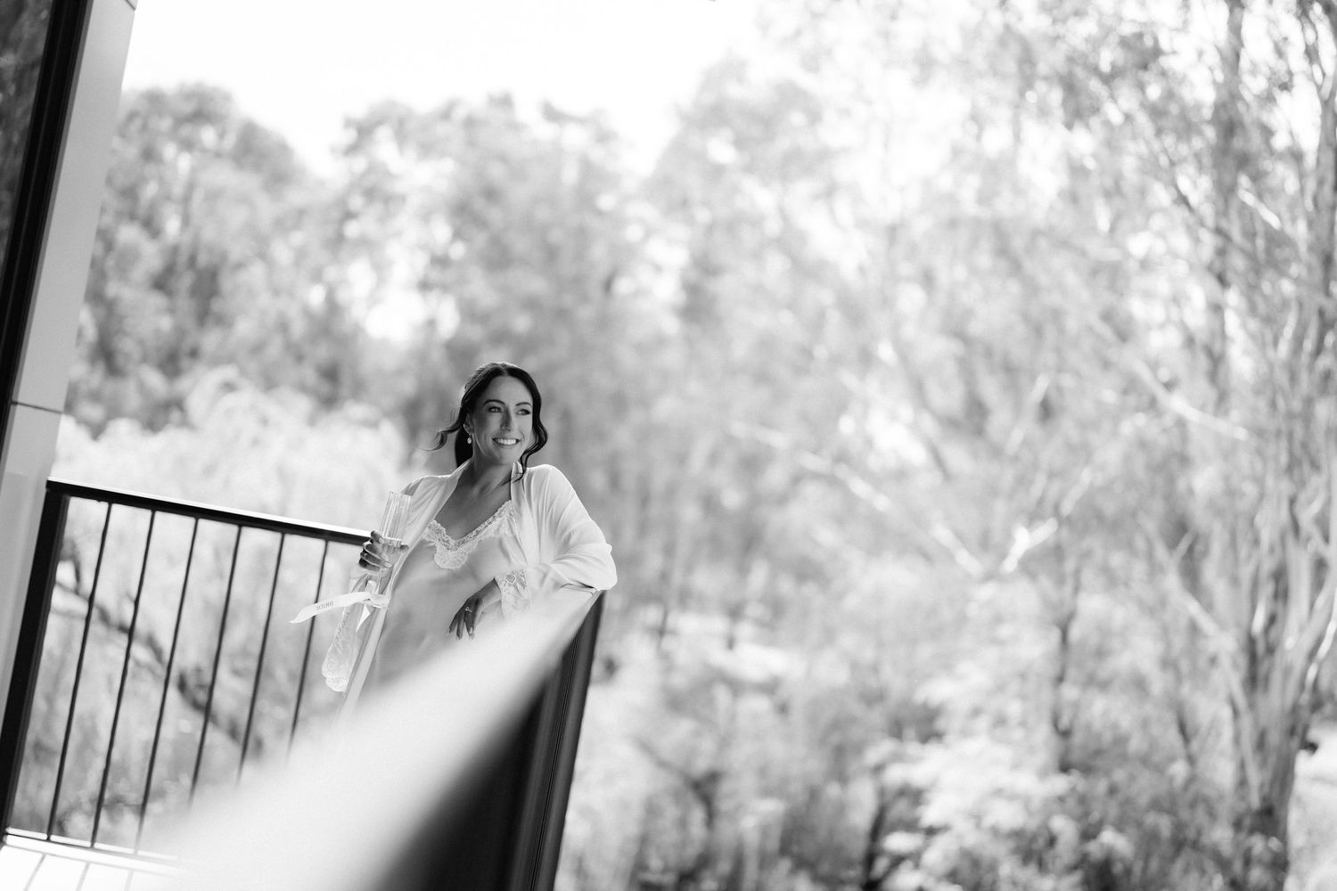 A series of black and white photos arranged in a filmstrip-style layout showing a romantic outdoor portrait session.