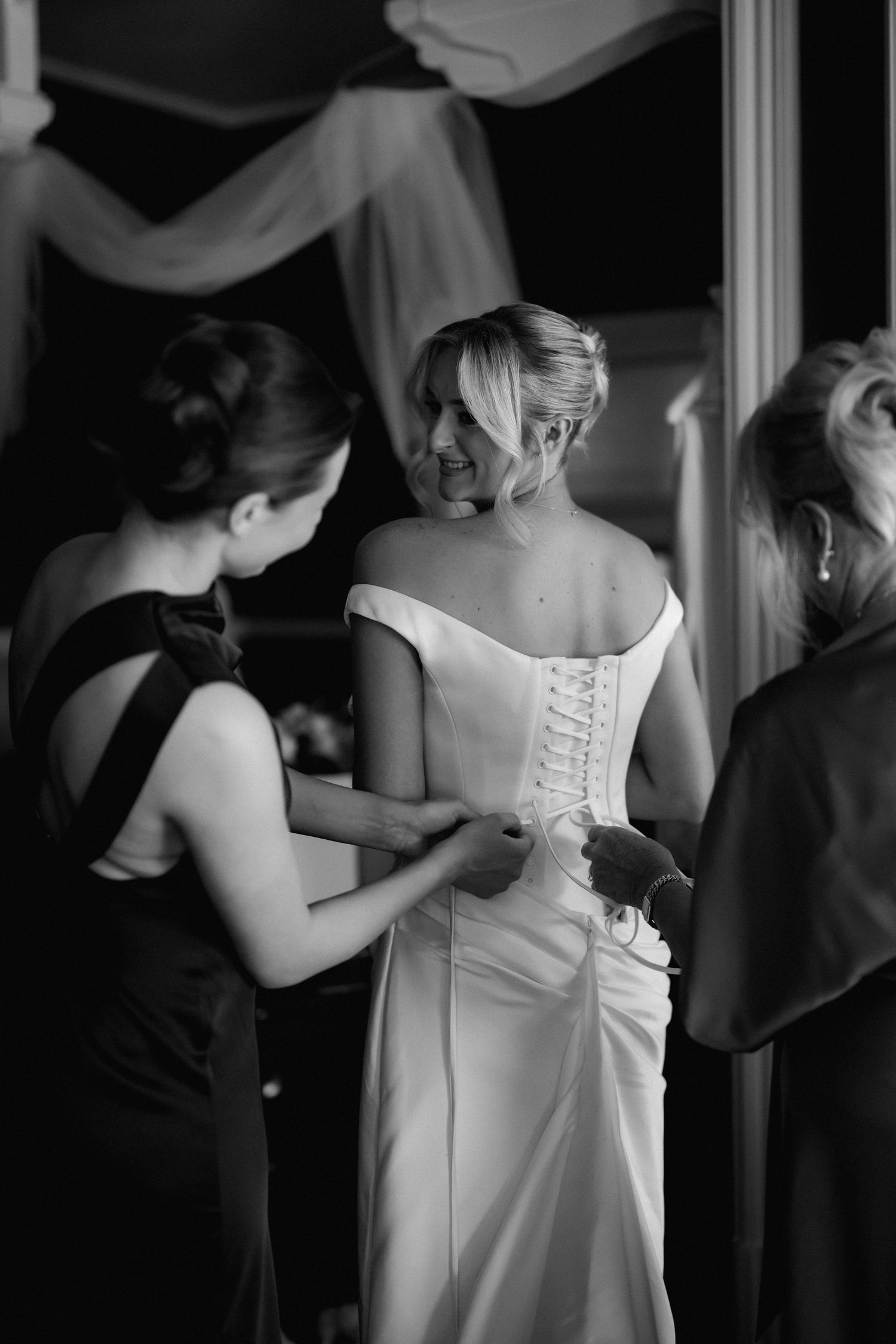 Close-up of white wedding dress details showing lace-up back.