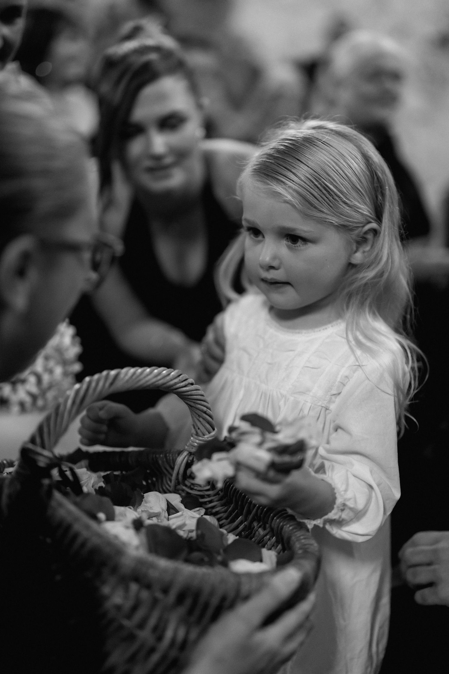 A series of black and white photos showing a young child interacting with a butterfly.
