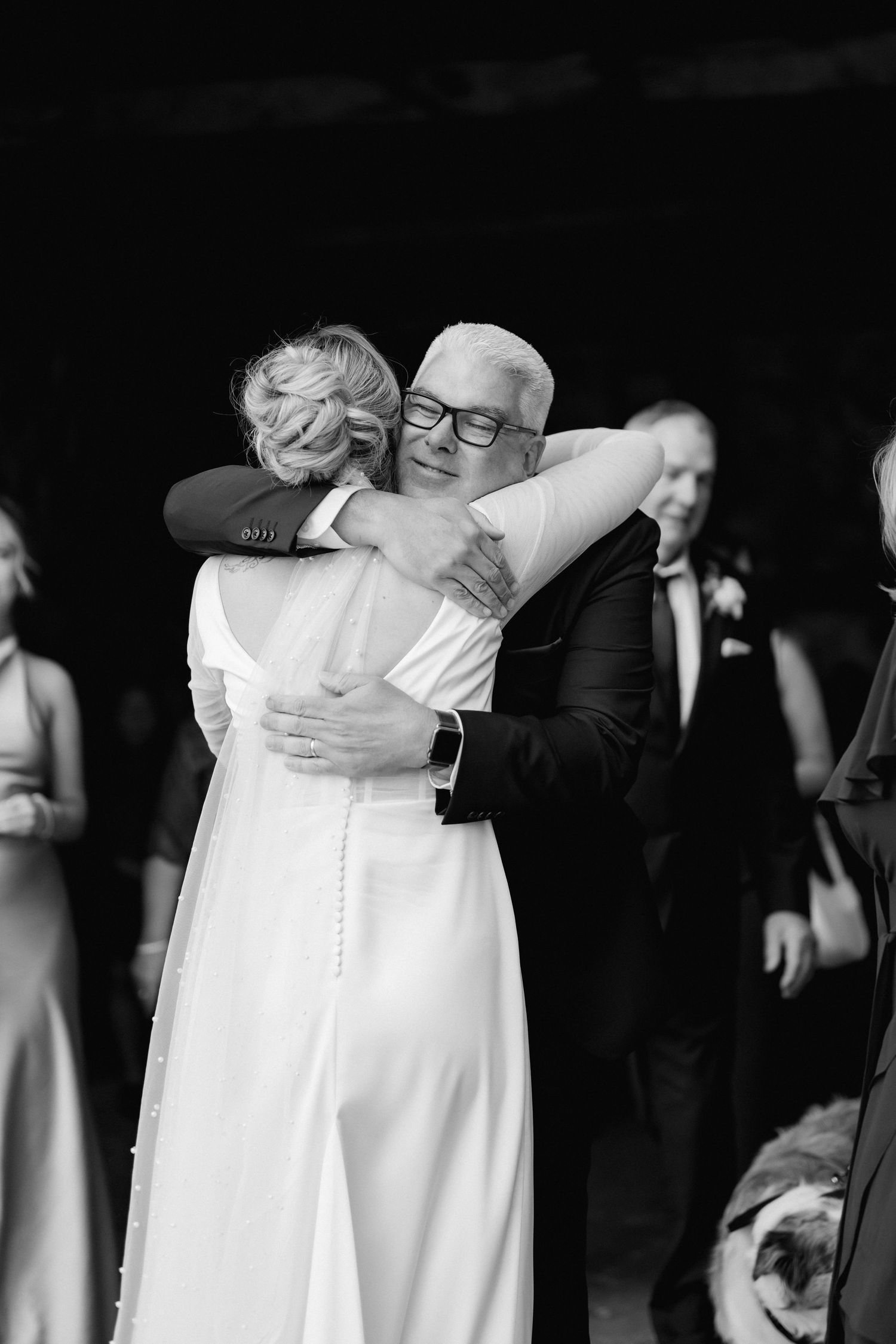 Black and white images capture intimate moments of support between wedding party members.