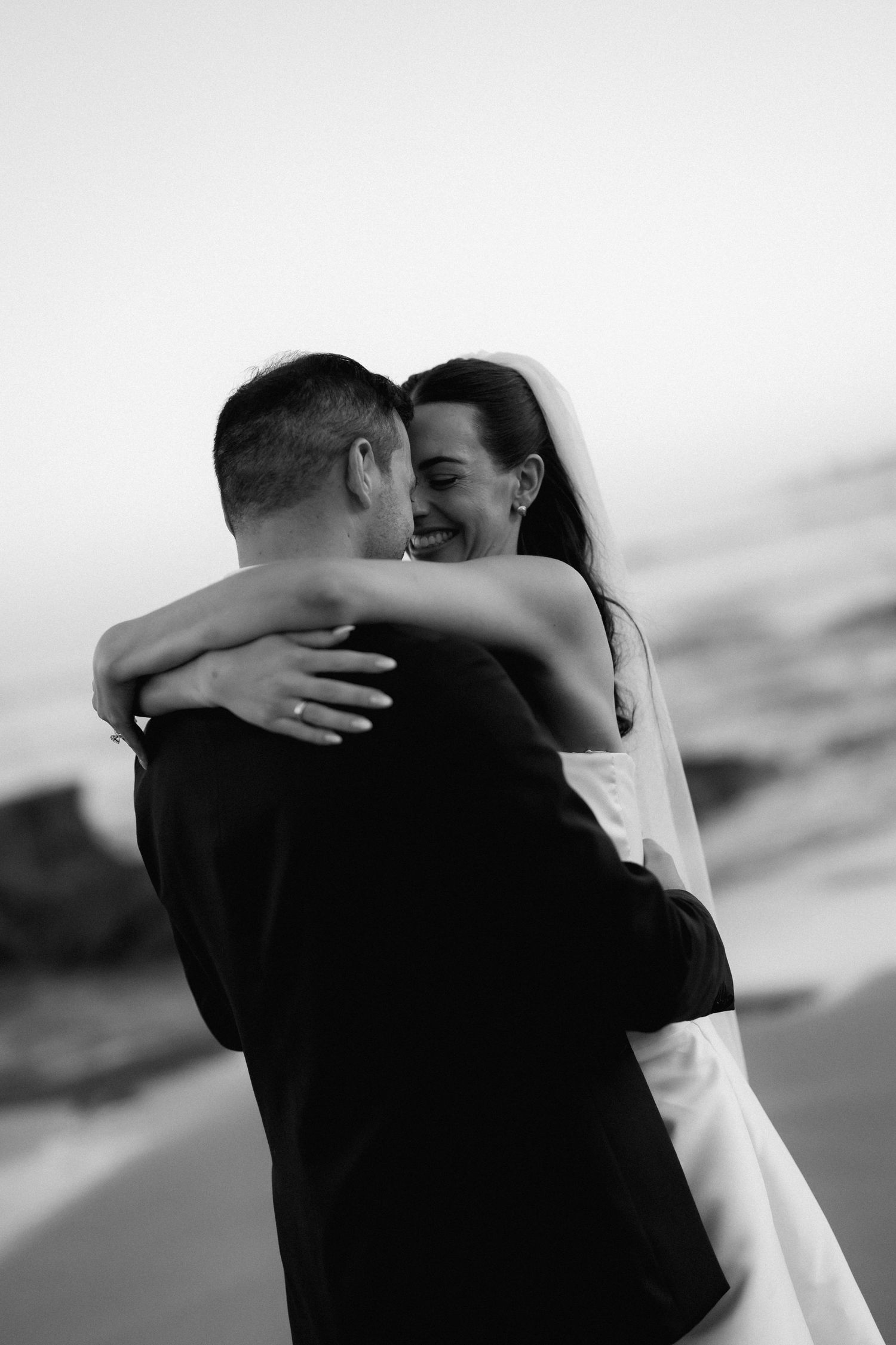 A romantic black and white photo series captures intimate moments between a couple on their wedding day.