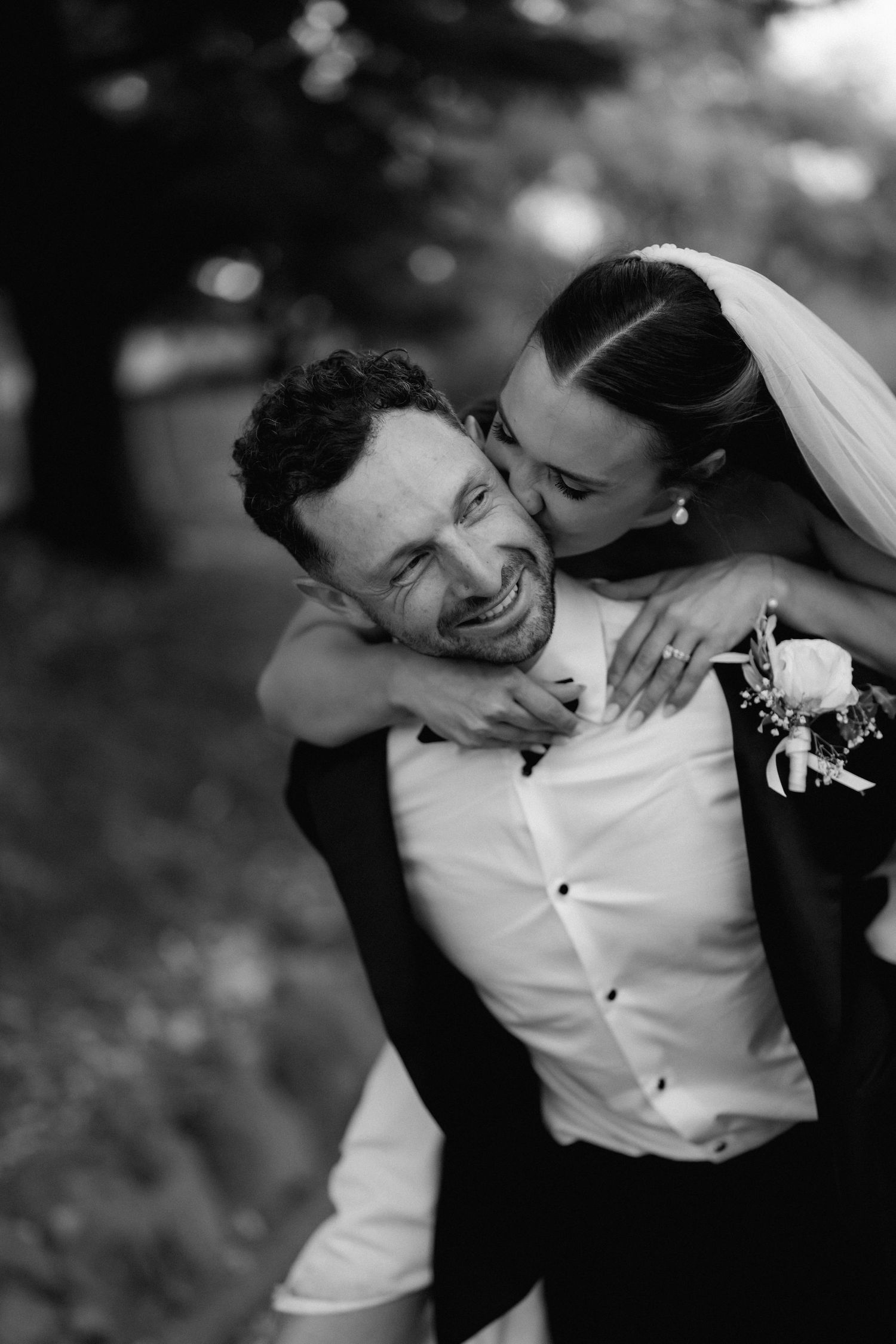 Candid black and white photos capture joyful moments between bride and groom.