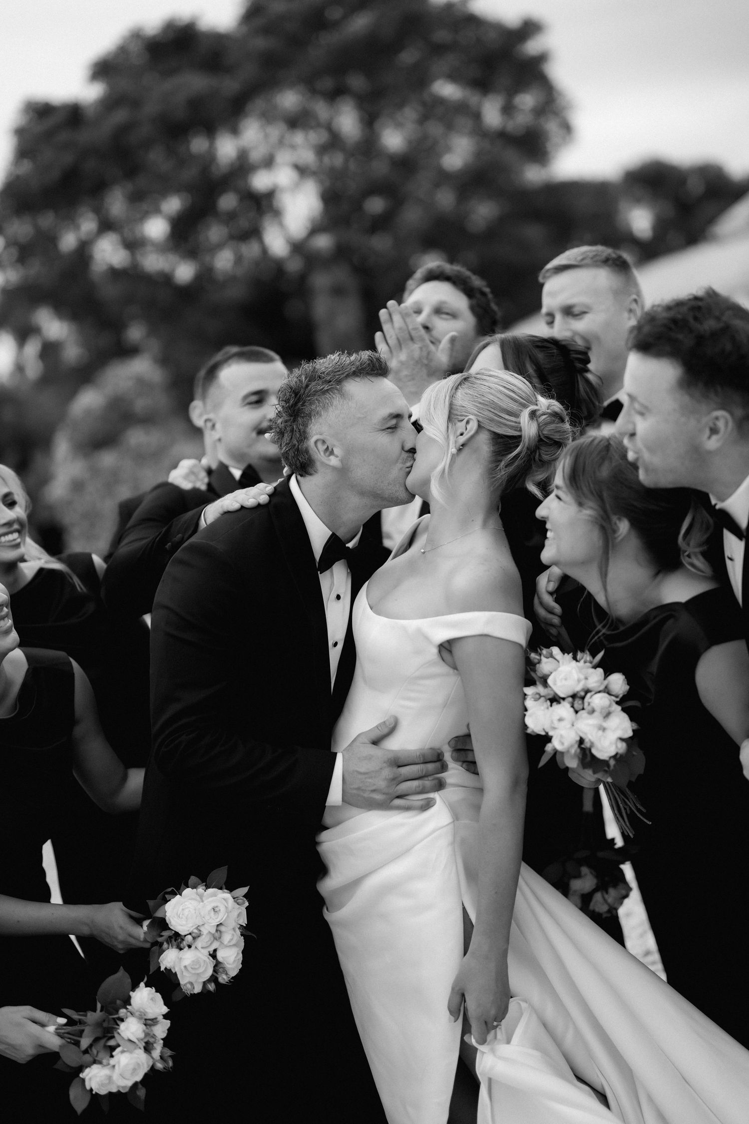 Wedding party shares intimate candid moments in black and white photo series.