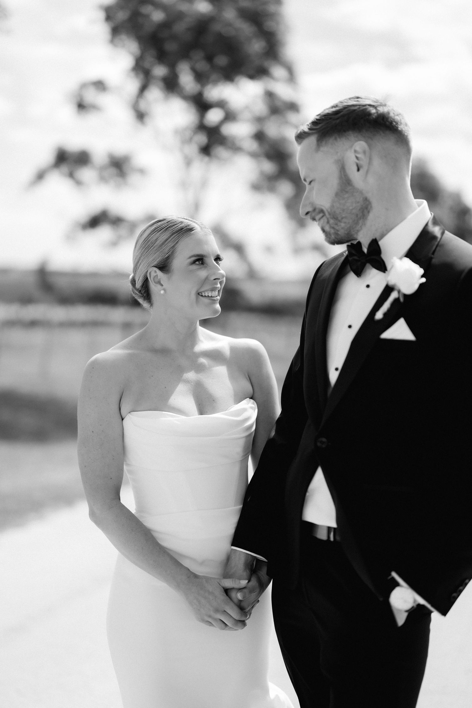 Black and white romantic portraits of newlyweds sharing intimate moments.