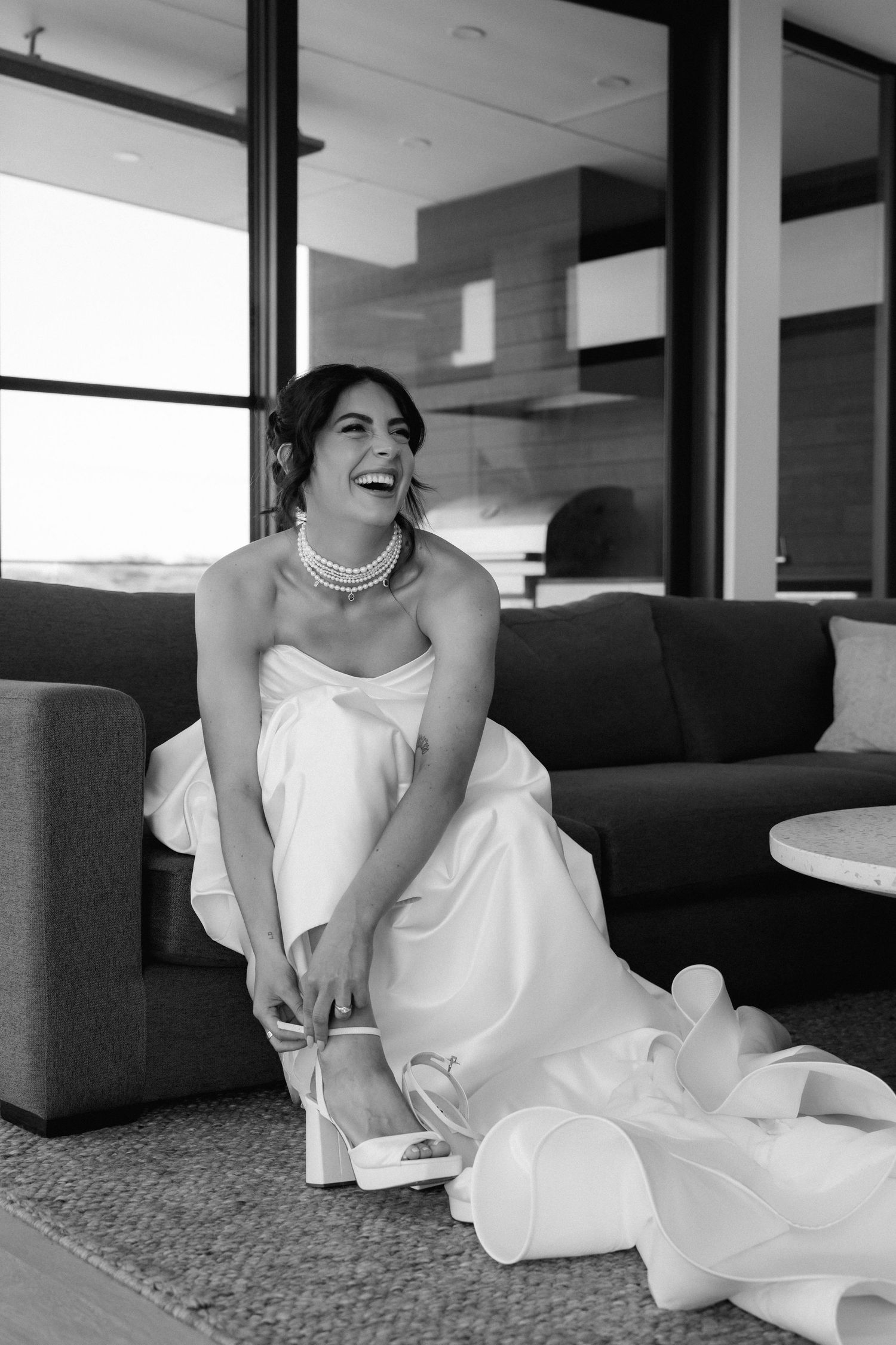 Joyful moment captured on a modern grey couch in a contemporary setting.