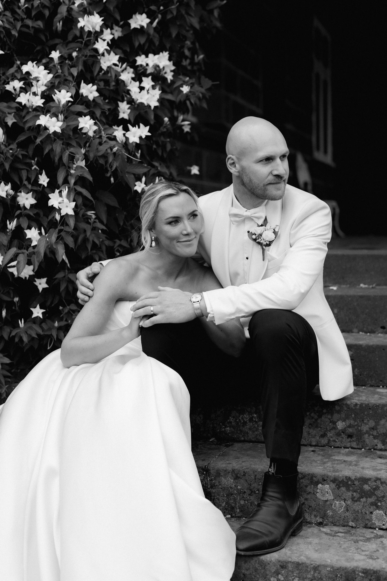 Romantic black and white wedding portrait on garden steps.