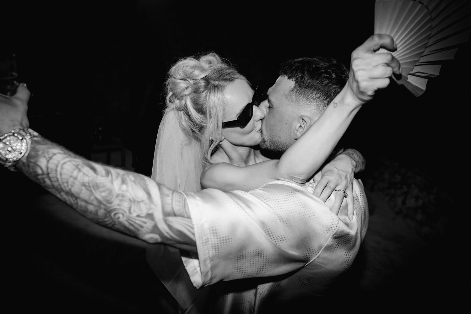 A dramatic black and white photo of a couple's first dance with elegant movements.