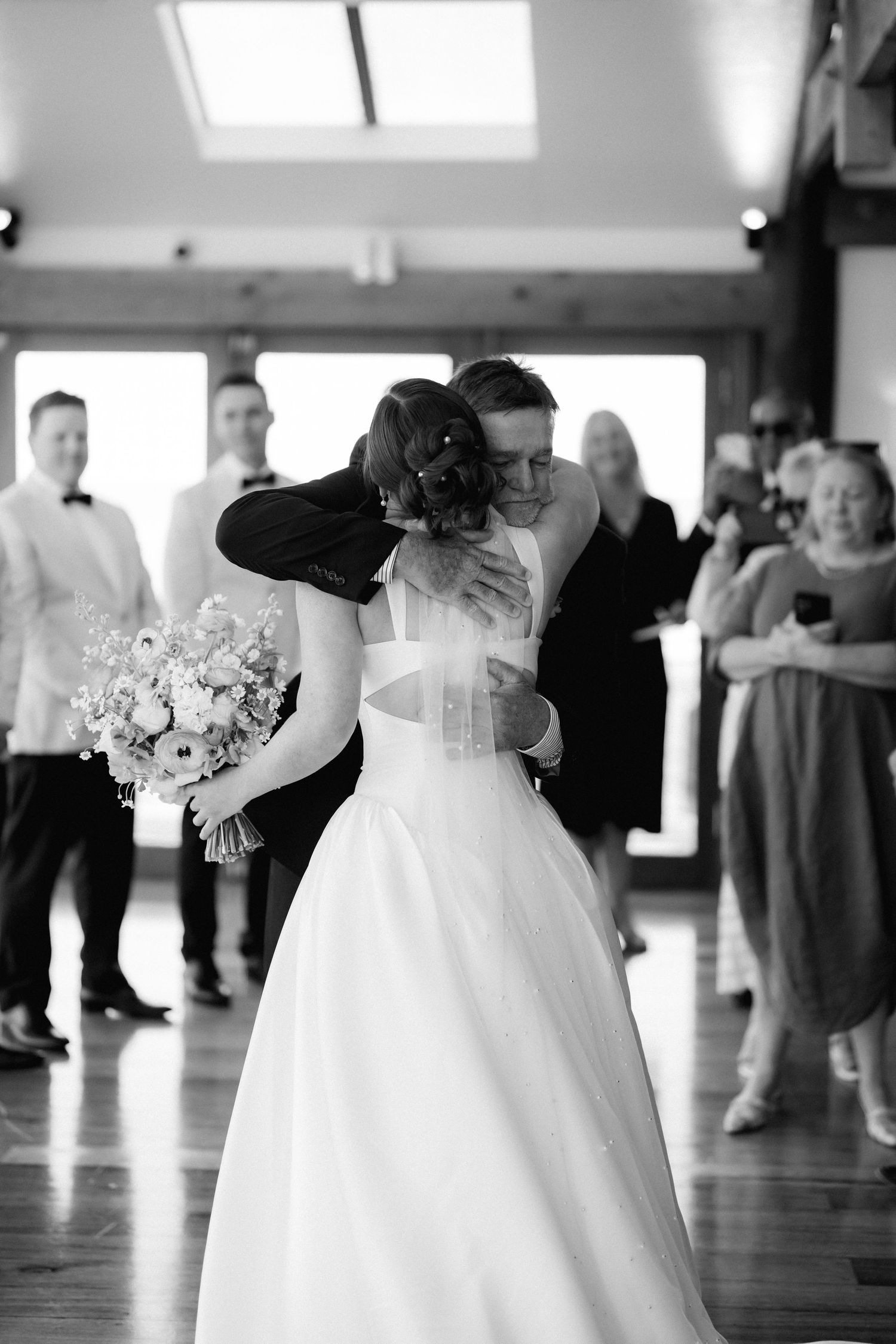 Multiple wedding dress shots showing flowing white gowns during a dance on a hardwood floor.