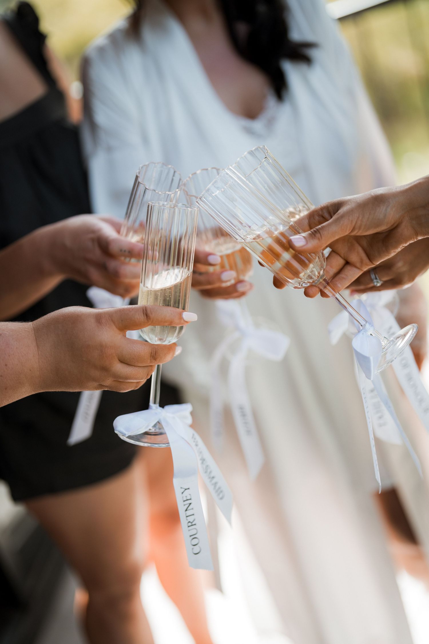 Wedding party members toasting with champagne glasses in a celebratory sequence.