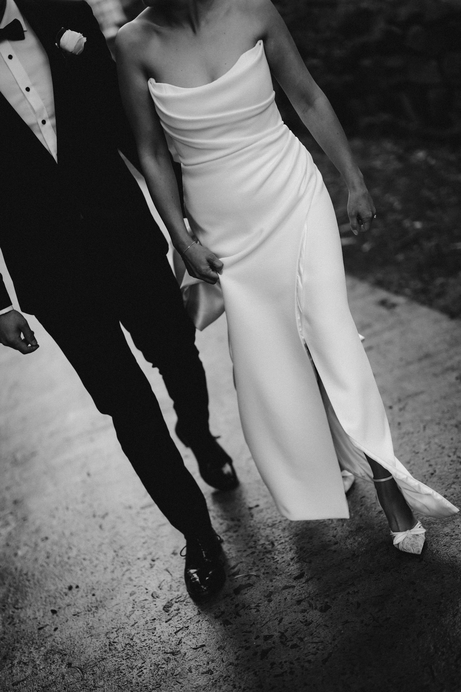 Black and white detail shots of formal shoes and dress hem during an elegant dance sequence.