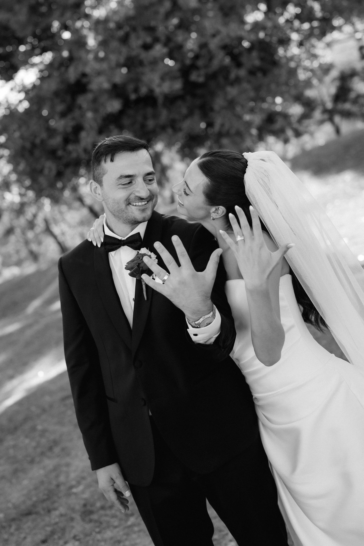 Black and white candid wedding portraits capturing joyful laughter and intimate moments.