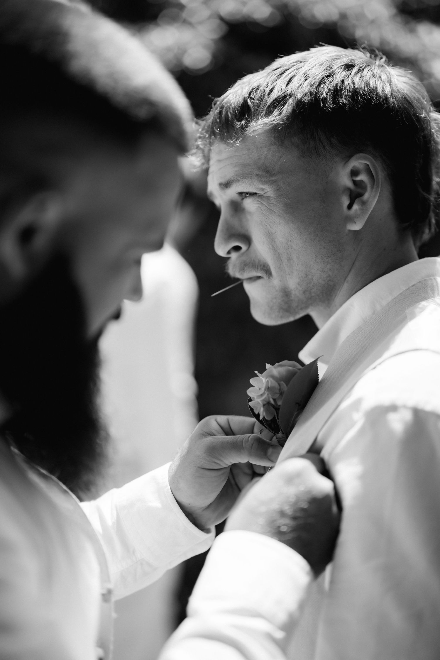 Black and white close-up portraits of a couple sharing intimate moments during their wedding day.