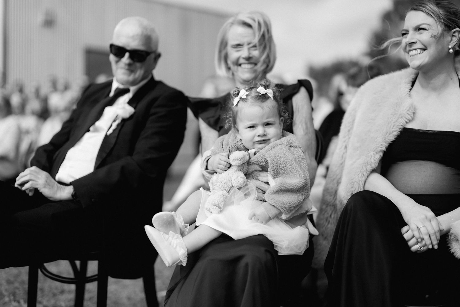 Black and white candid shots of wedding guests enjoying the celebration.