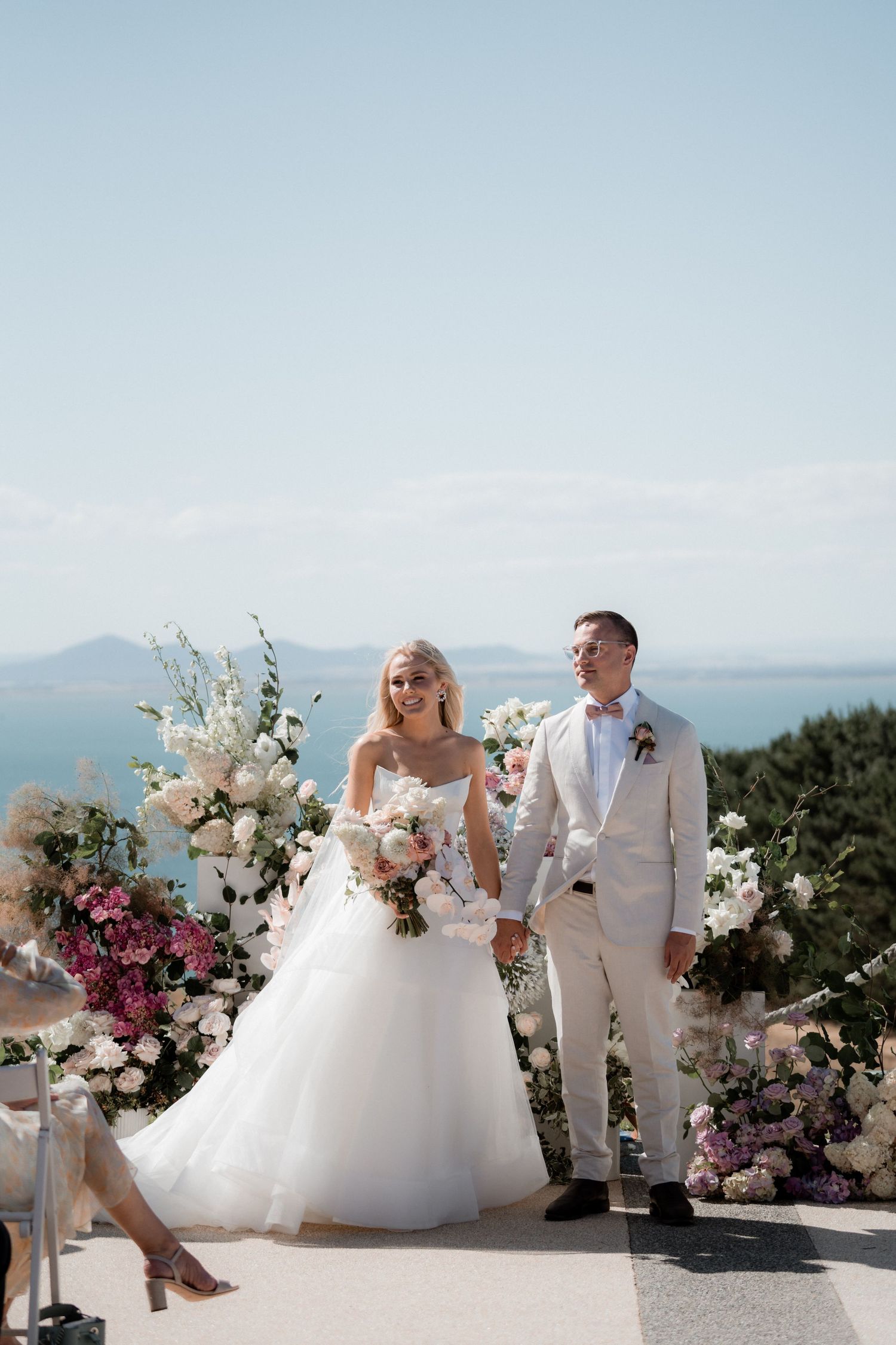 A coastal wedding ceremony setup with stunning ocean views and floral arrangements.