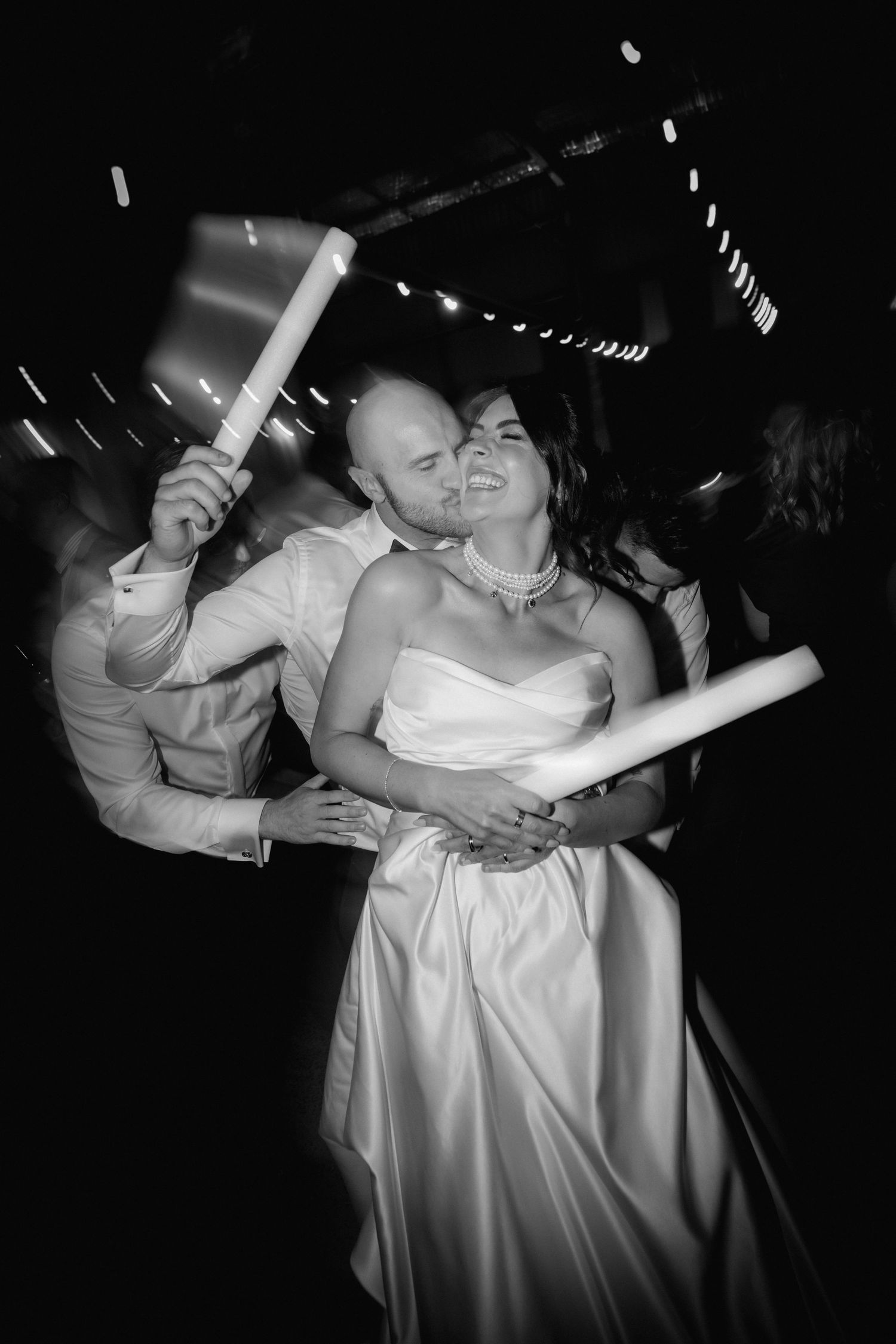 Couple shares intimate dance moves in black and white photography.