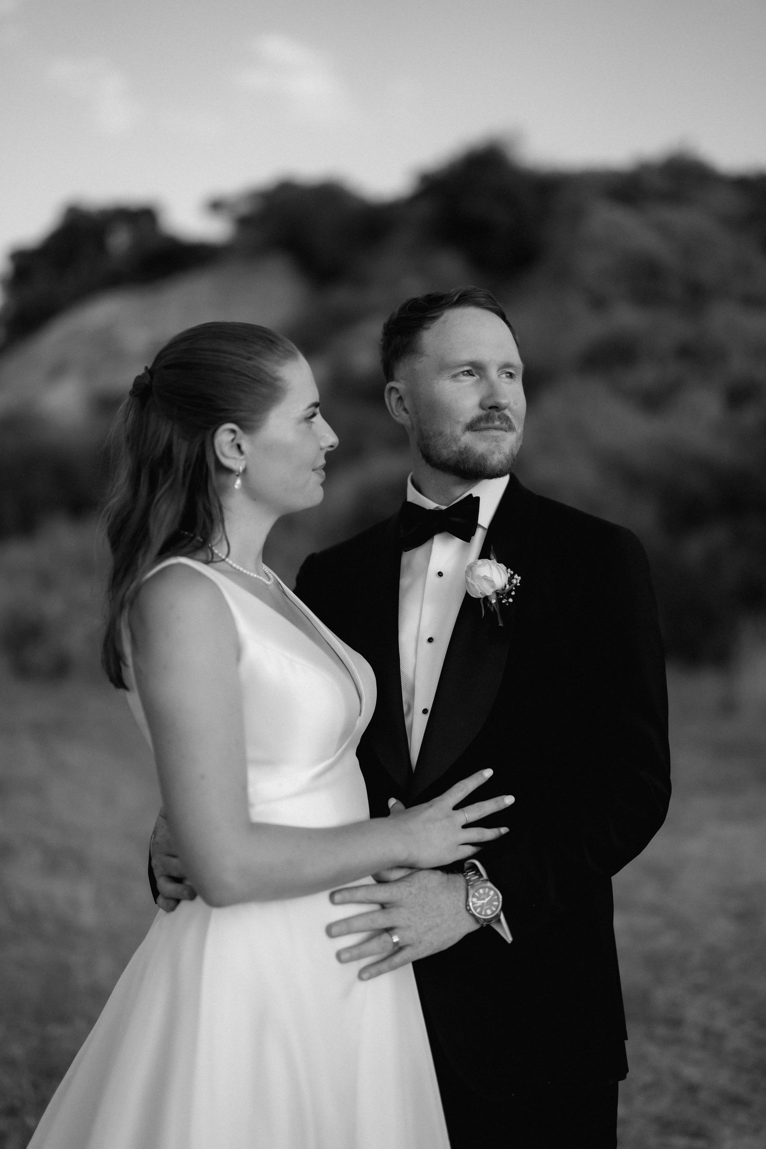 A couple sharing an intimate moment during their wedding photoshoot in black and white.