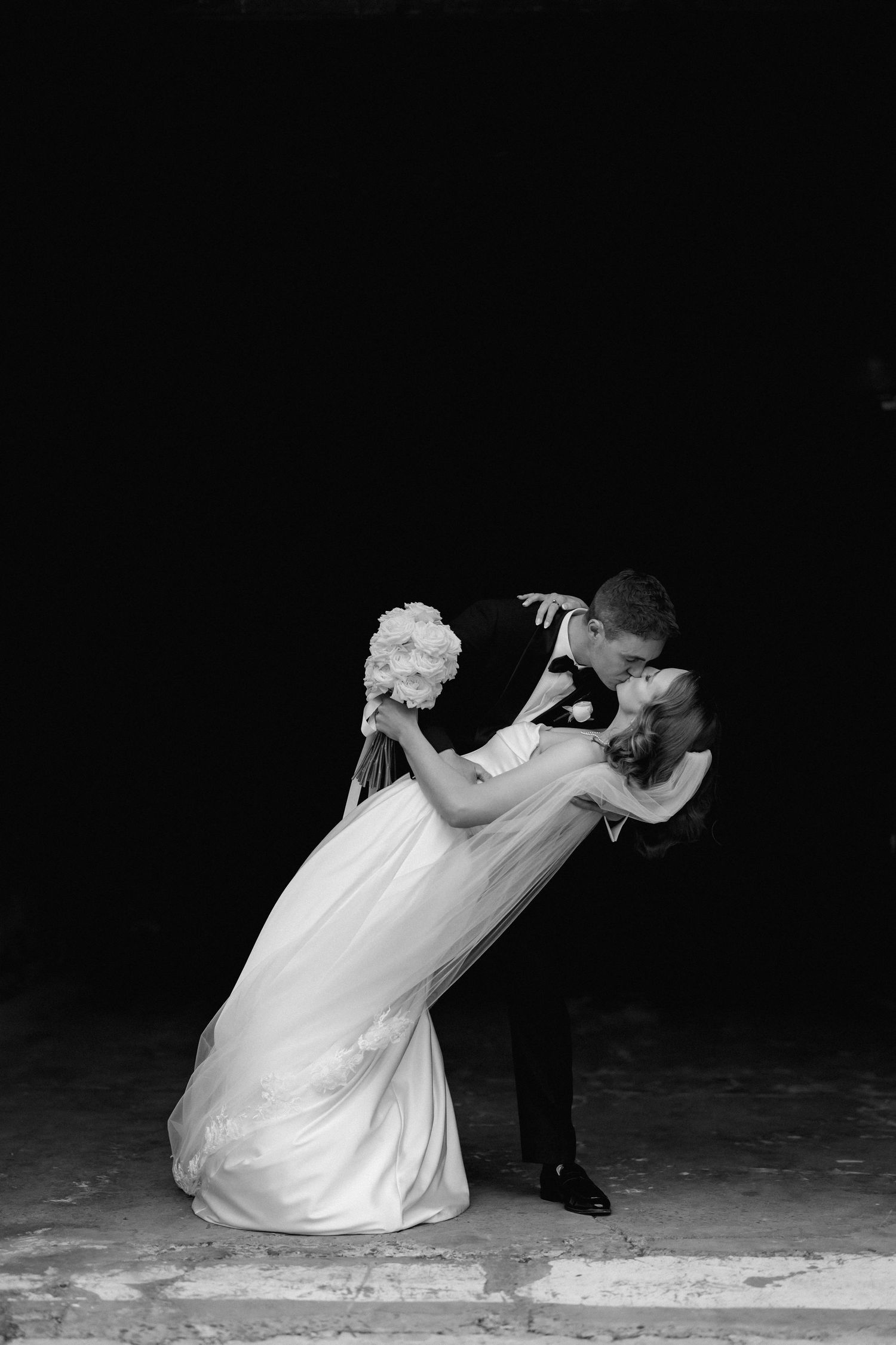 Dramatic black and white photos capture a couple's romantic dance dip sequence.